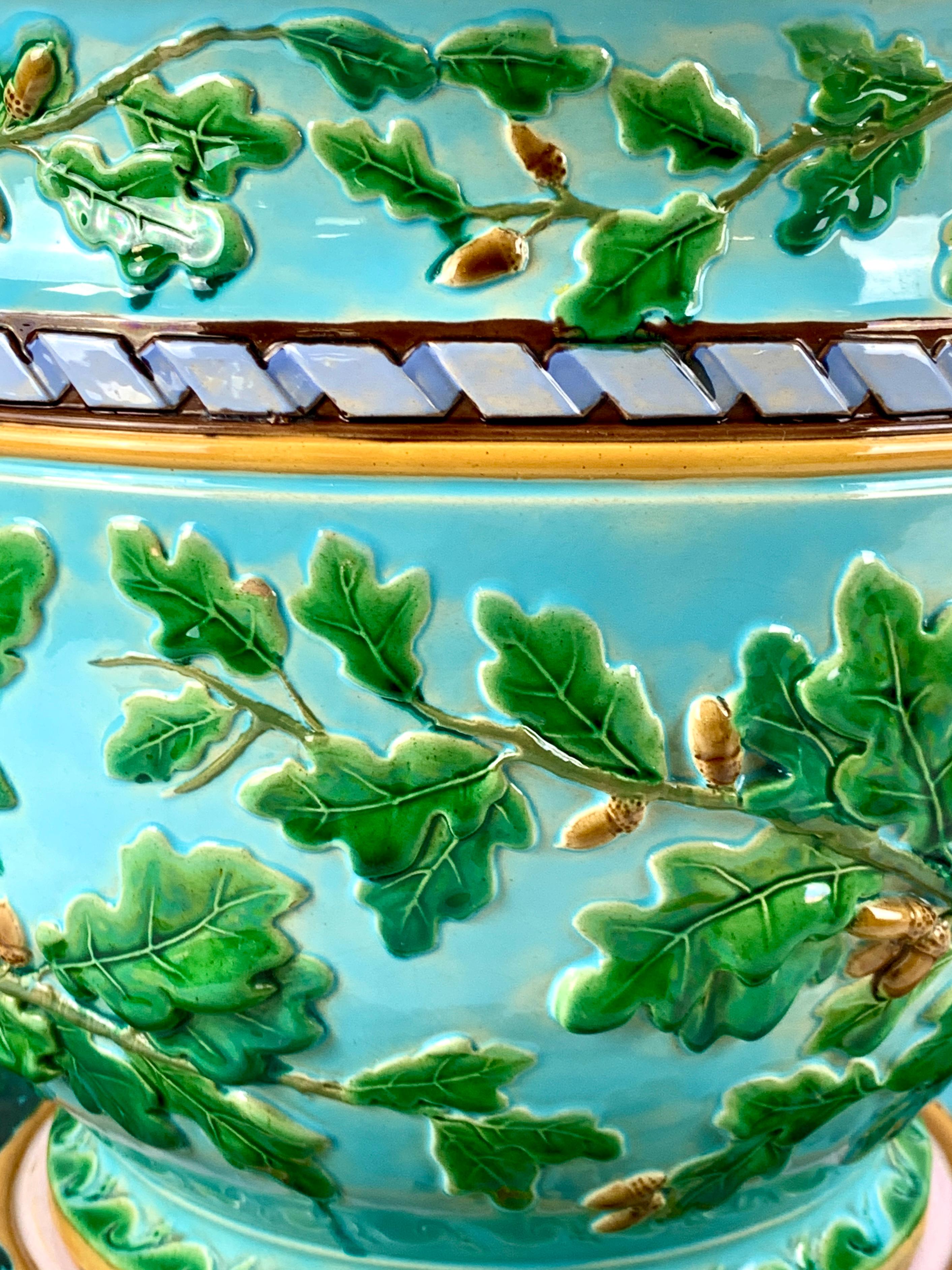 This exquisite 19th-century majolica jardiniere and underplate by Minton was handpainted in Stoke-upon-Trent, Staffordshire, England, around 1880. This jardiniere measures an impressive 17