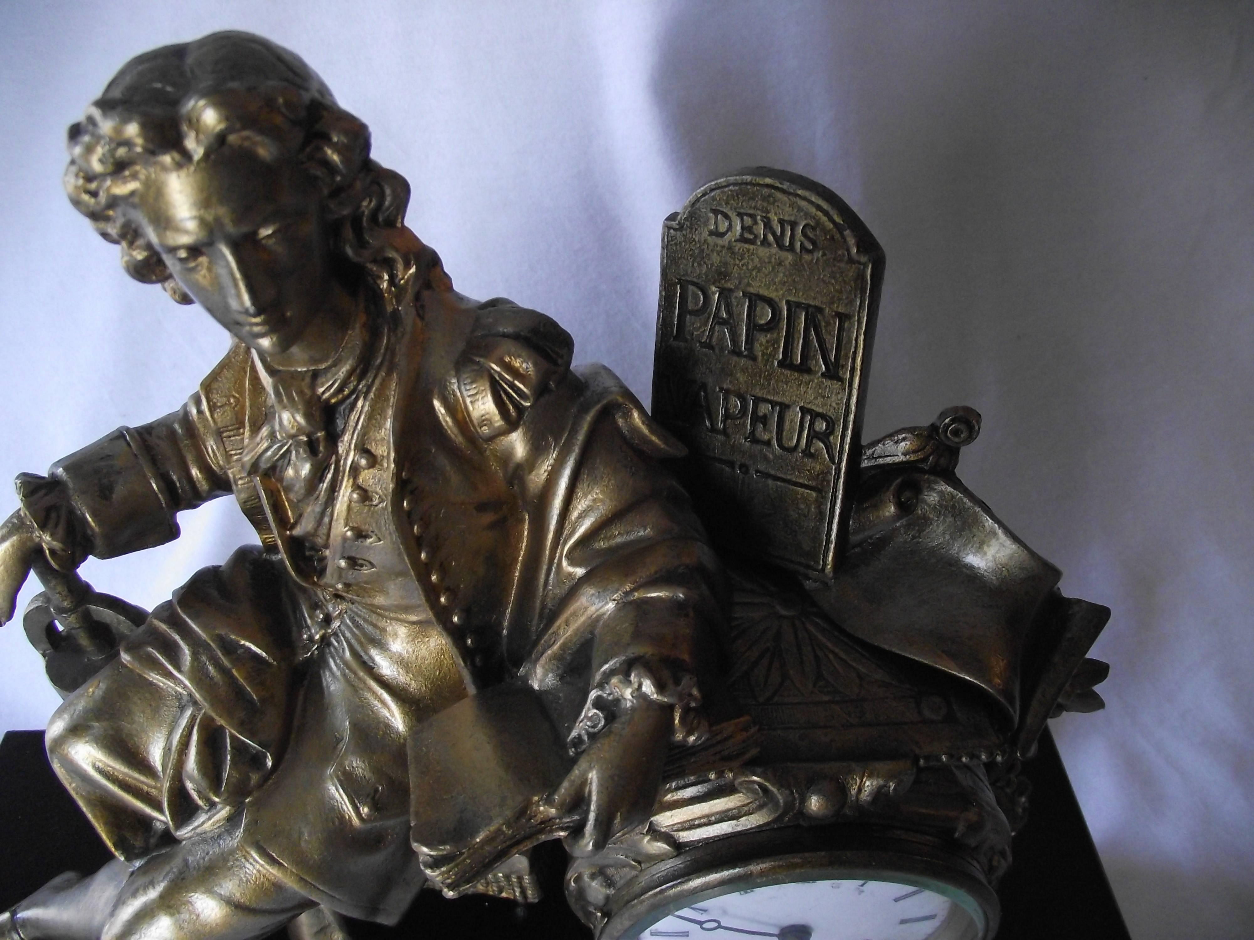 Impressive marble large marble clock features a gilt sculpture of a sitting Denis Papin.

 Clock works have been cleaned and restored by a certified horologist. It is in very good condition. The hours are counted by a delicate little bell which