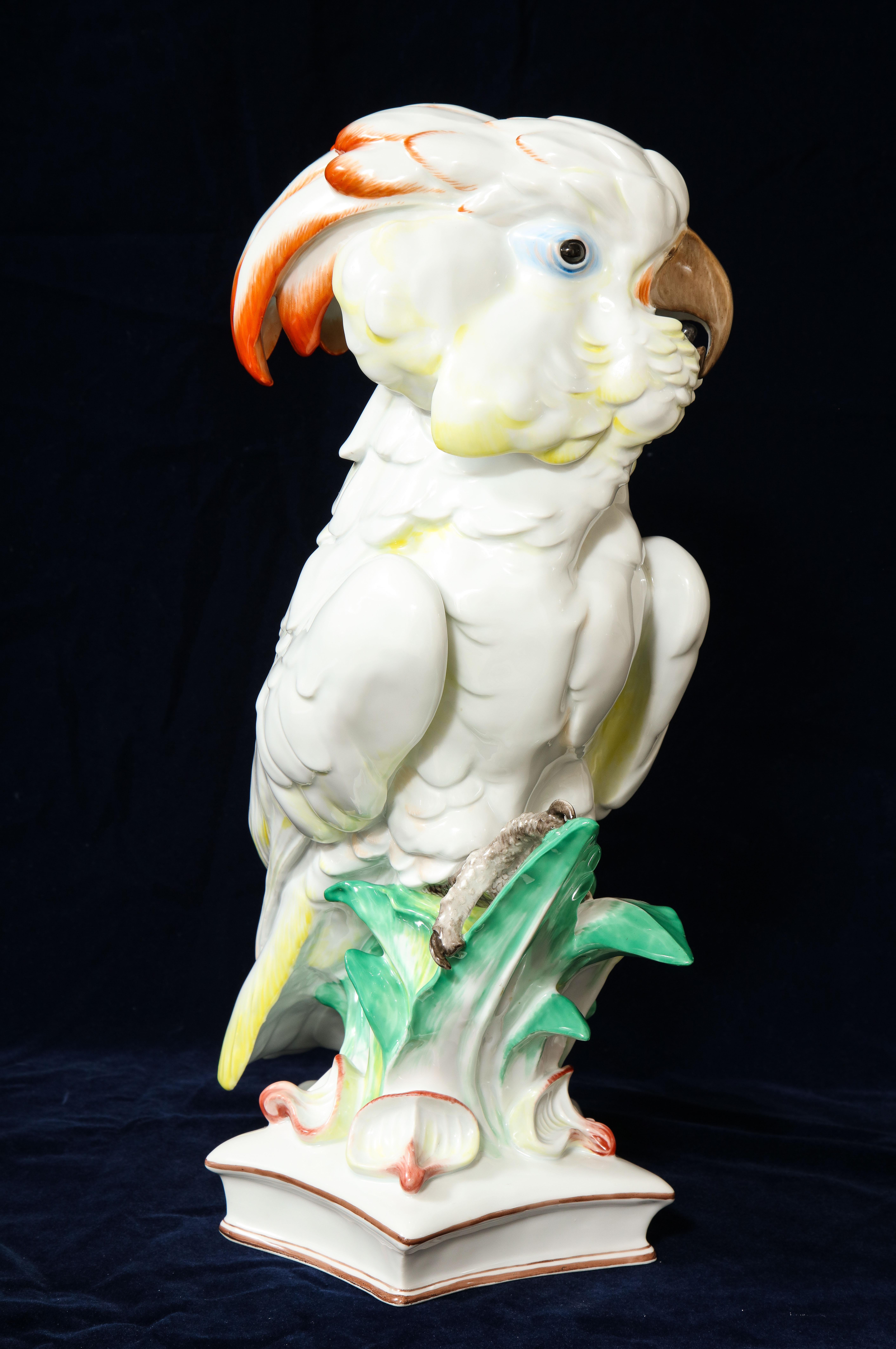 A delicately and very naturalistically colored and beautifully modeled Meissen Porcelain figure of a cockatoo seated on an exotic palm tree branch, with underglaze blue Pfeiffer crossed swords with incised numbers. Modeled by Wather as a perched