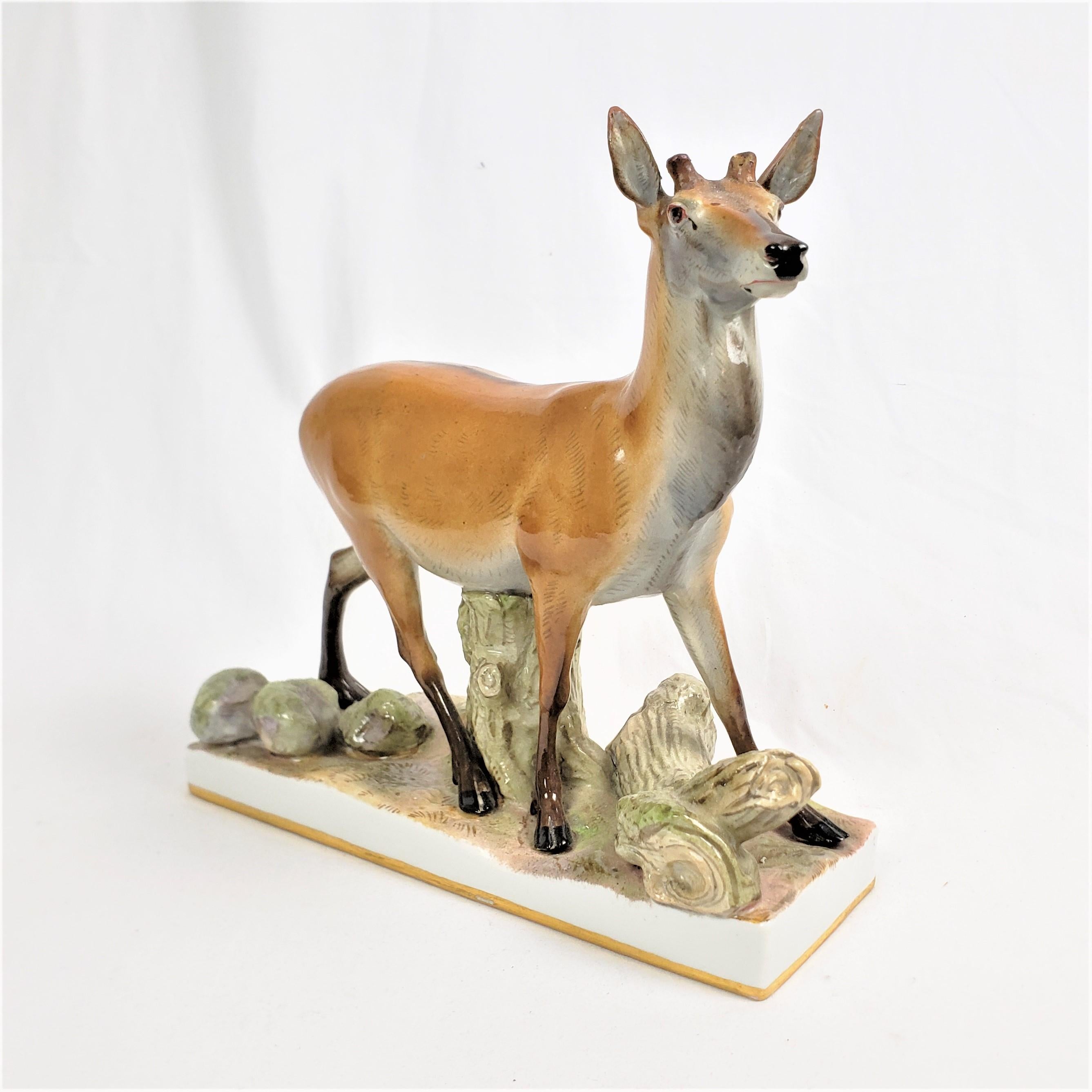 This large antique figurine was made by the renowned Meissen factory of Germany in approximately 1880 in the period realistic style. The figurine or sculpture is composed of porcelain and depicts a standing deer resting his belly on a stump. The