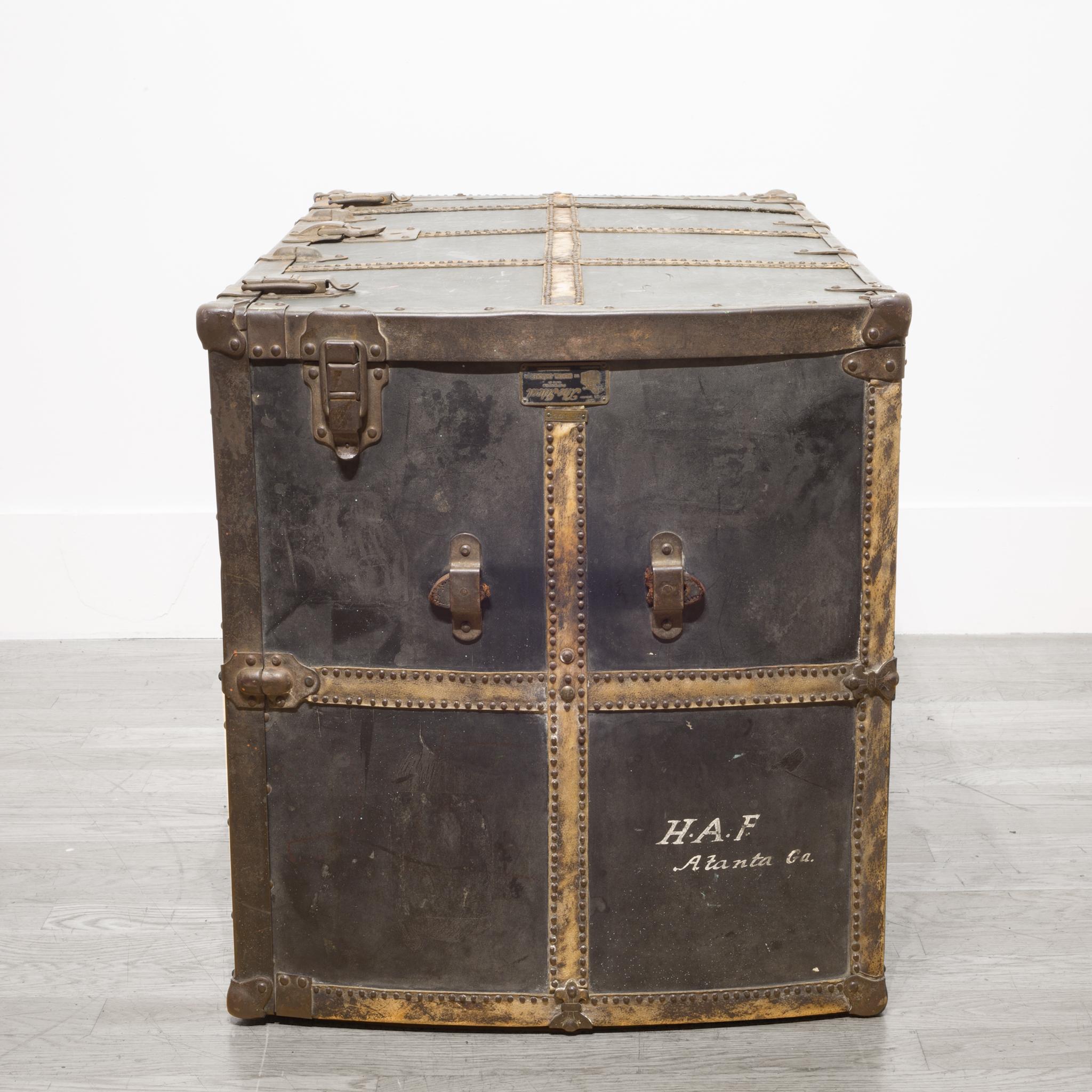 About

This is a large metal trunk with riveted metal bands and the original metal label by Mendel Drucker. The trunk opens up with sliding hangers and drawers with secret compartments. The trunk can be turned on its side and used a