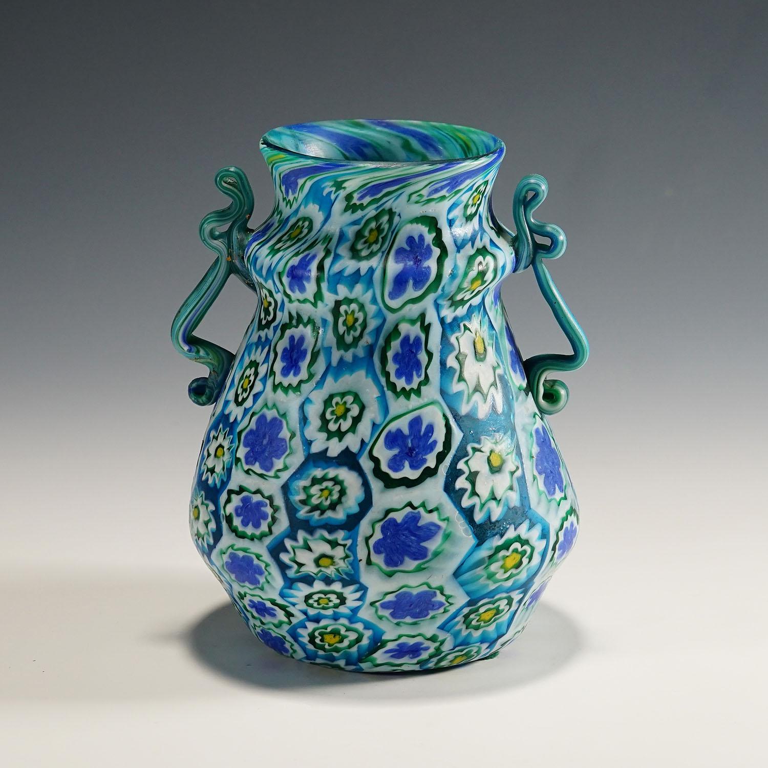 Large Antique Millefiori Vase with Handles, Fratelli Toso Murano, 1910

A large and rare millefiori murrine glass vase manufactured by Vetreria Fratelli Toso, Murano around 1910. Made of polycrome murrines (blue, green, jellow and white) which where