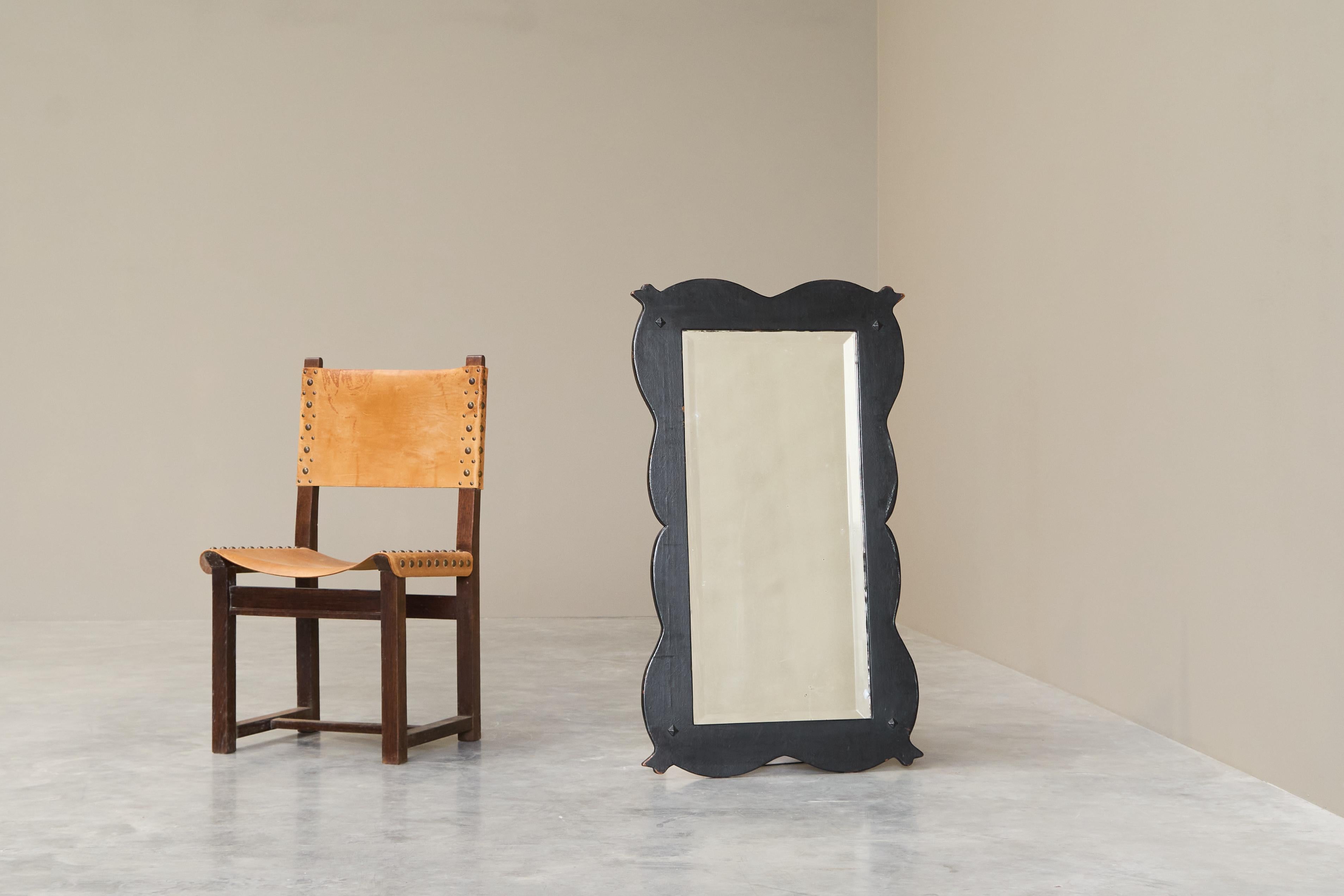 Large Antique Mirror in Ebonized Wood and Facetted and Weathered Mirror Glass.

Sculptural and large antique mirror in ebonized wood and weathered mirror glass. Wonderful sculptural shape - most probably Dutch and mid 19th century. Comes from a
