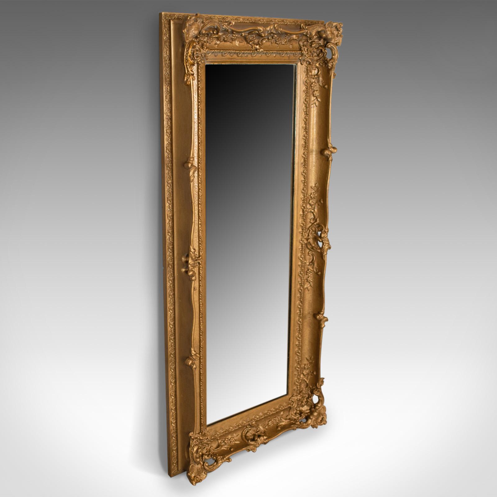 This is a large antique mirror, a tall, English, Victorian, gilt gesso dressing mirror dating to the mid-19th century, circa 1850.

A super period gilt gesso frame
Victorian in the classical taste
Decorated with scrolls, foliate detail and