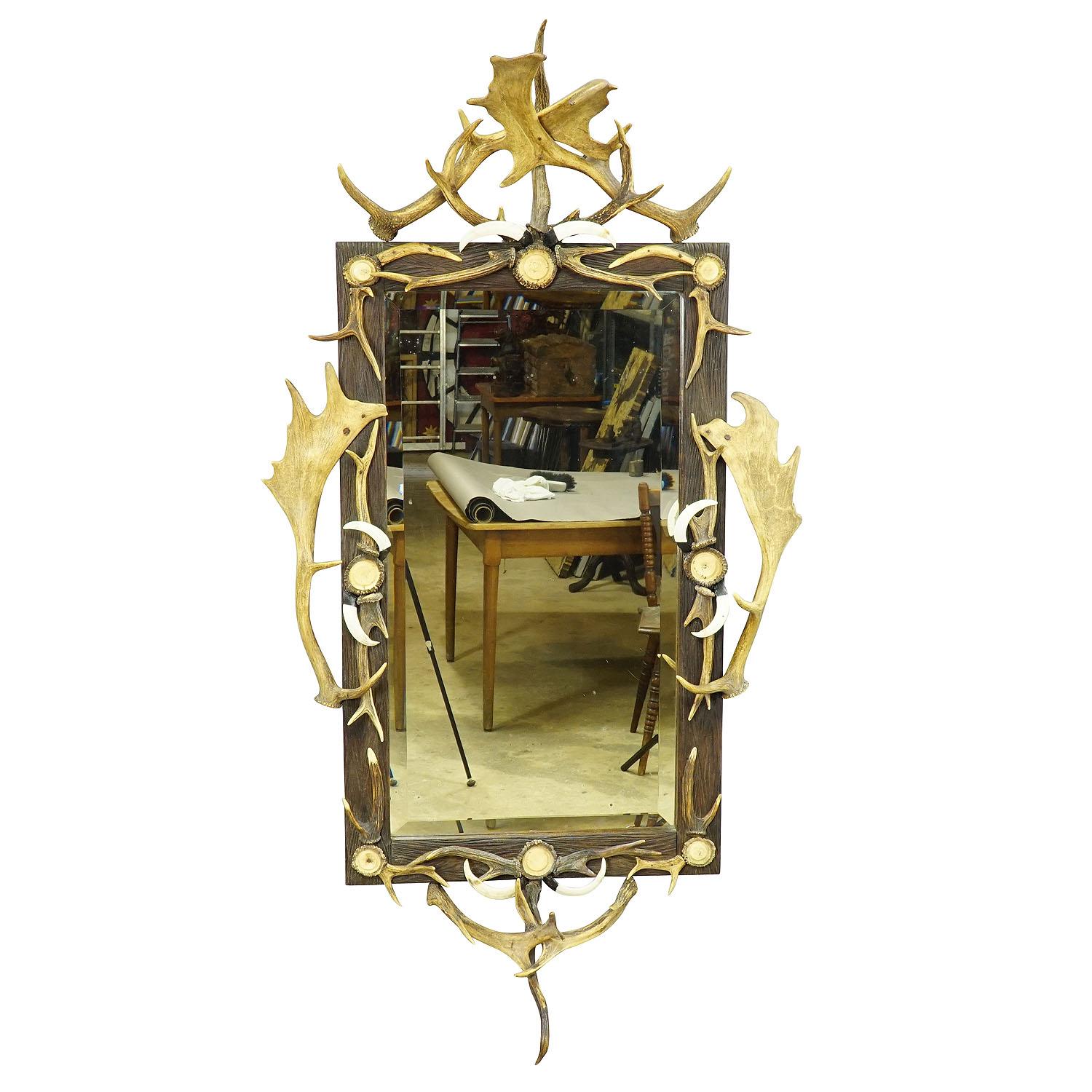 Large Antique Mirror with Rustic Antler Decorations

A large impressive antler mirror decorated with turned horn roses and antler pieces of the deer, fallow deer and virginia deer. Made in Germany, Black Forest circa 1910.

Antler furniture have