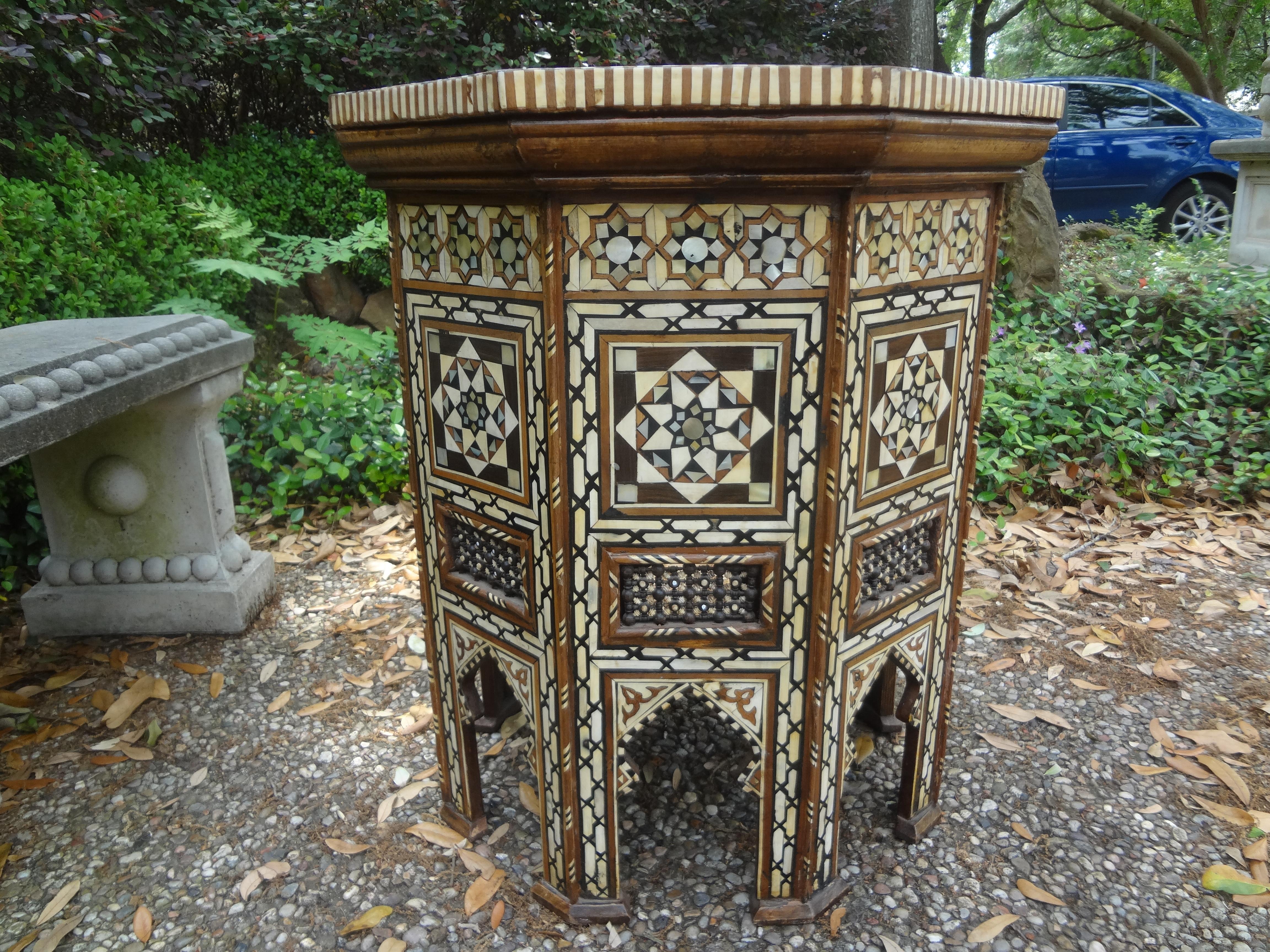 Large antique Moroccan Arabesque style octagonal inlaid table.
This stunning Moroccan octagon shaped table is inlaid with various woods, bone and mother of pearl and dates to the 1920s. Great side table, center table, accent table, occasional table