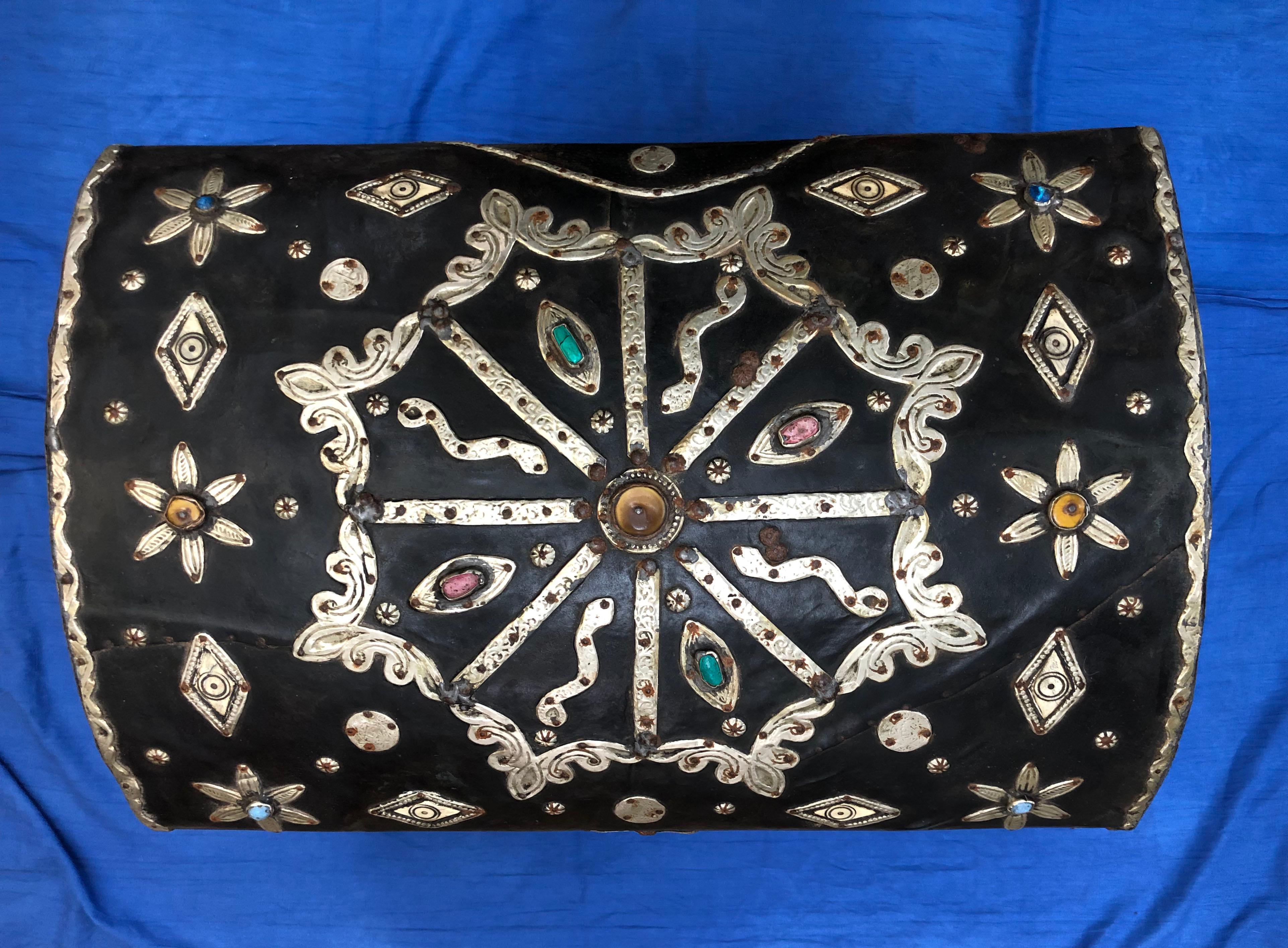 This antique dowry trunk was originally filled with fine clothes and bedding and presented by a husband to his future wife. Made in southern Morocco, it dates from the early 1900s and is mahogany covered in leather, with silver and brass repousse,