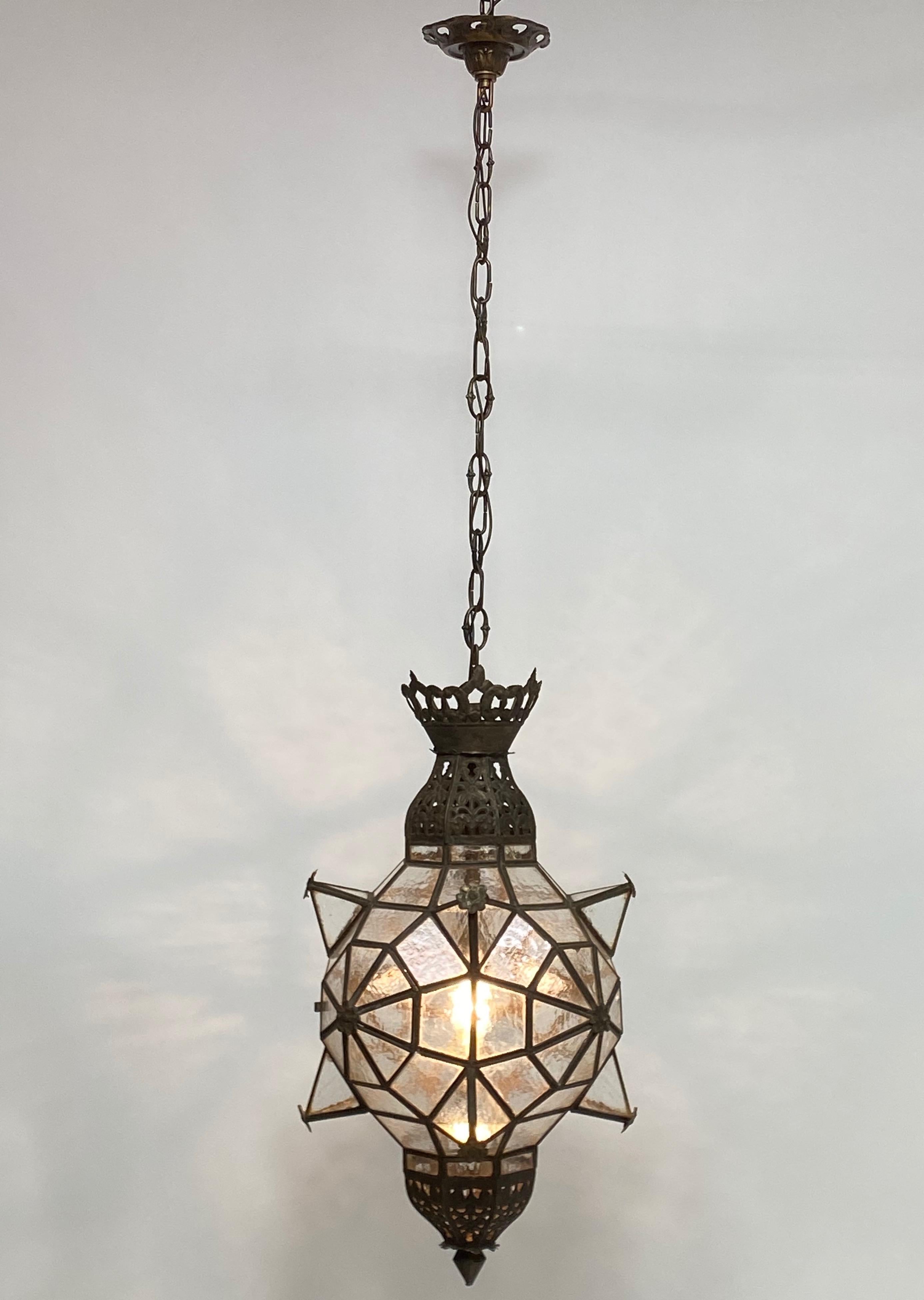 Wonderful old handcrafted Moorish style lantern having its original glass panels and patina. Originally this light fixture held candles but is now electrified, holds a single standard size bulb.
In superb condition.
Early 20th century (possibly