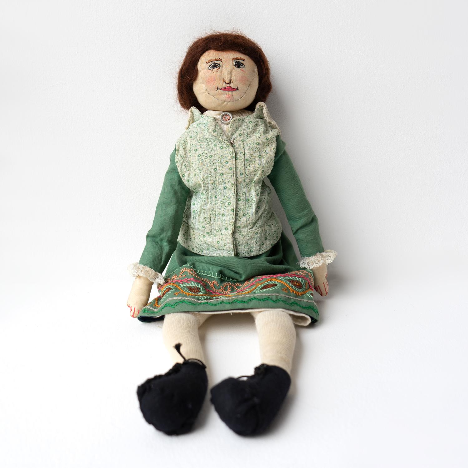 LARGE FOLK ART RAG DOLL

An adorable and individual cloth doll lovingly hand-stitched with embroidered facial features, rosy cheeks and braided human hair.

Charming hand-stitched clothing including a green jacket with lace collar and cuffs, a
