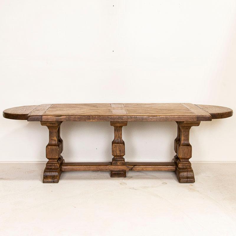 This oak table creates drama due to the massive legs, thick top and unique rounded ends. Notice the patterns in the oak top and use of wood pegs instead of nails. This trestle table has been restored and is in strong, stable condition ready to use.
