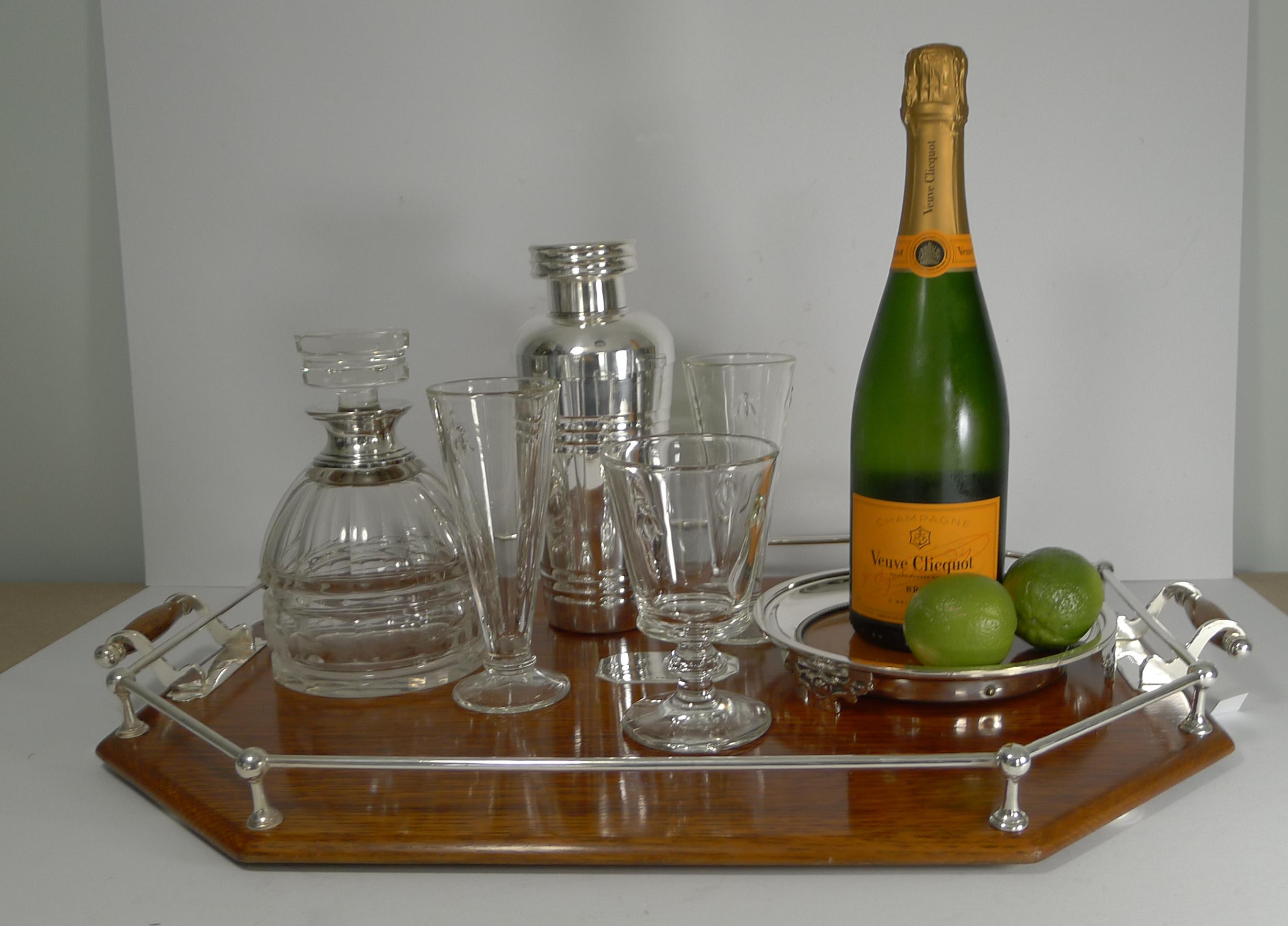A fabulous and grand sized serving tray, perfect to set out your home bar.

The base is made from solid English Oak, beautifully polished and mounted with a silver plated gallery and integral handles, marked EPNS in several places for