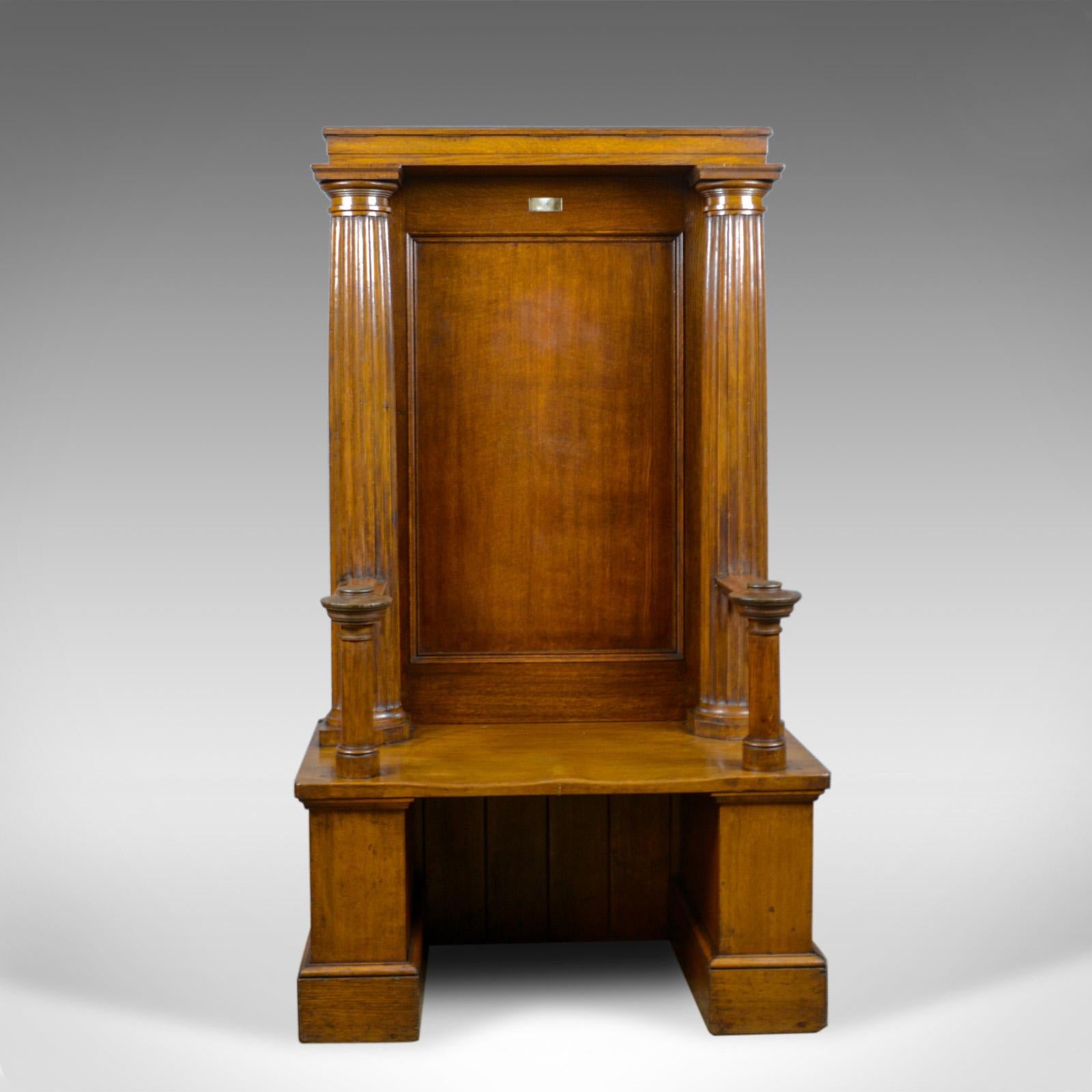 This is a large, antique, oak throne chair. An English, Edwardian bench seat with classical detail and Doric columns dating to the early 20th century, circa 1910.

Of large proportion and magnificent presence
Rich in color with a desirable aged