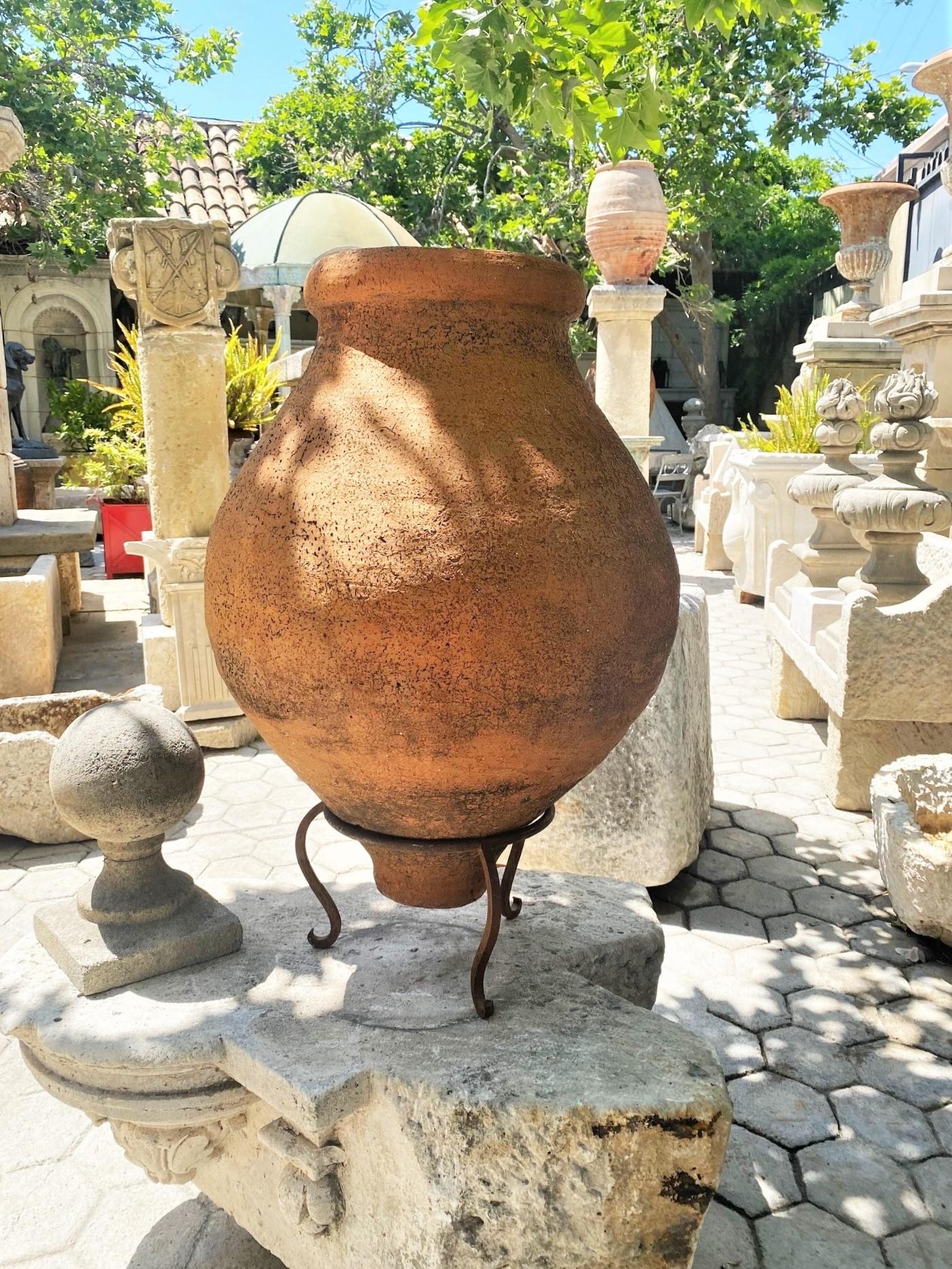 Outstanding 19th century Spanish olive oil jar in beautiful terracotta. A beautiful accent piece for any interior or exterior. Terracotta vessels once used to hold olives and olive oil features a rounded lip at the top, with a bulbous center which