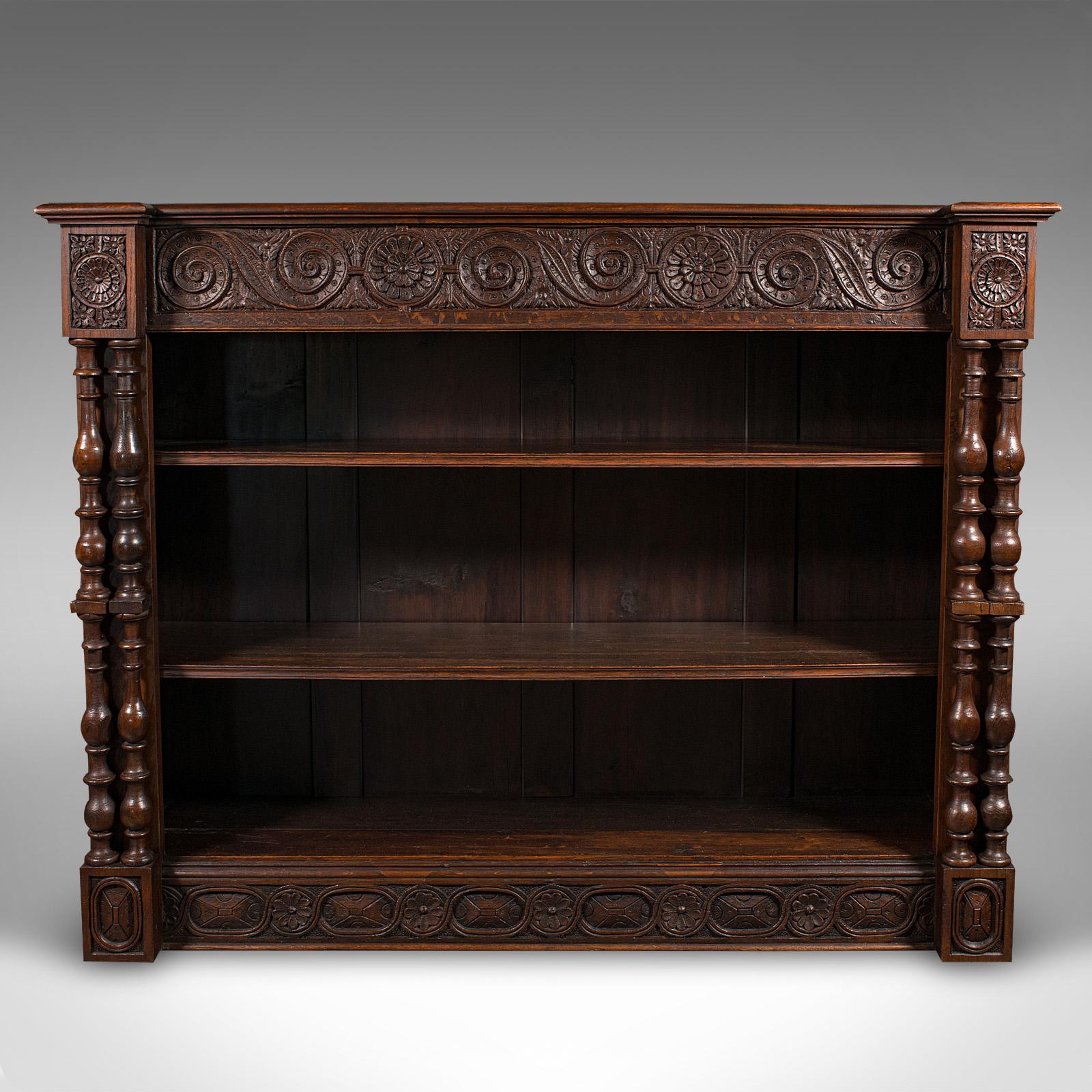 This is a striking antique Scottish oak open bookcase, dating to the Victorian period, circa 1880. This generously proportioned three-shelf book cabinet exudes Gothic Revival elegance, offering both practical storage and ornate