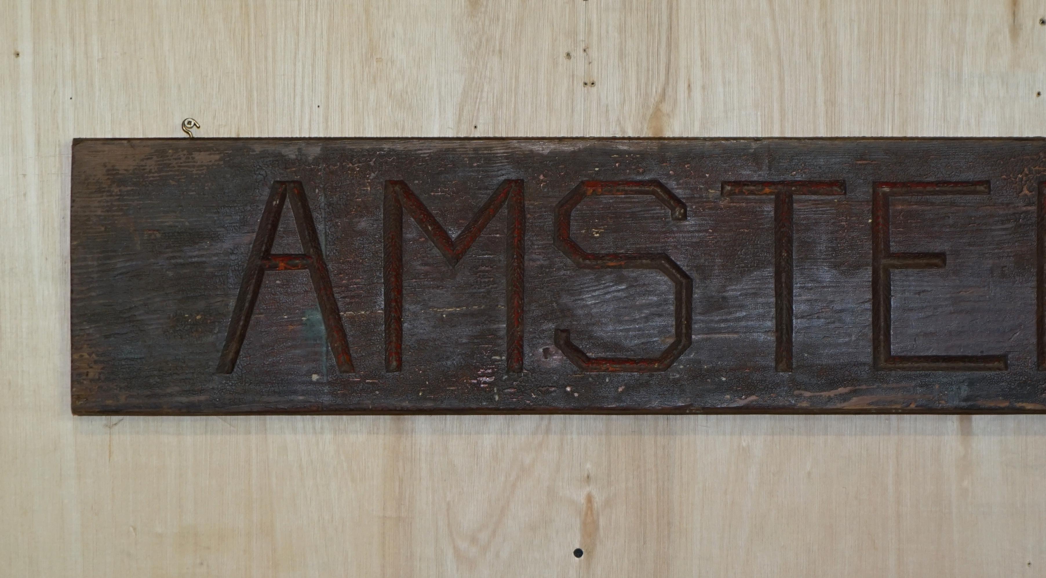 We are delighted to offer for sale this stunning hand carved original paint Amsterdam sign 

A very good looking and highly collectable and decorative piece, the paint is original and heavily distressed 

Dimensions

Height:- 26cm

Width:-