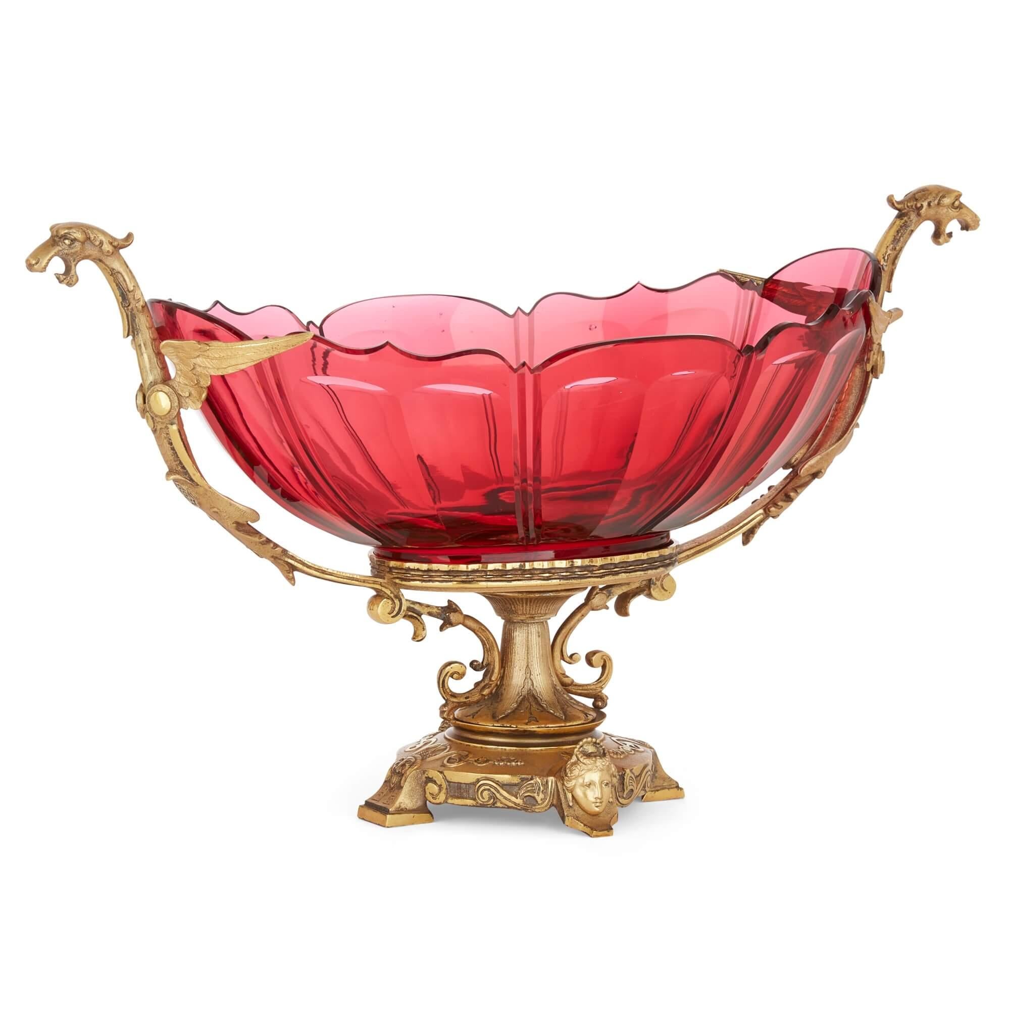 Large antique ormolu mounted red glass centrepiece suite by Baccarat
French, Late 19th Century  
Cornucopia: Height 38cm, width 24cm, depth 19.5cm 
Dish: Height 31cm, width 53cm, depth 25.5cm 

This outstanding large centrepiece suite was crafted in