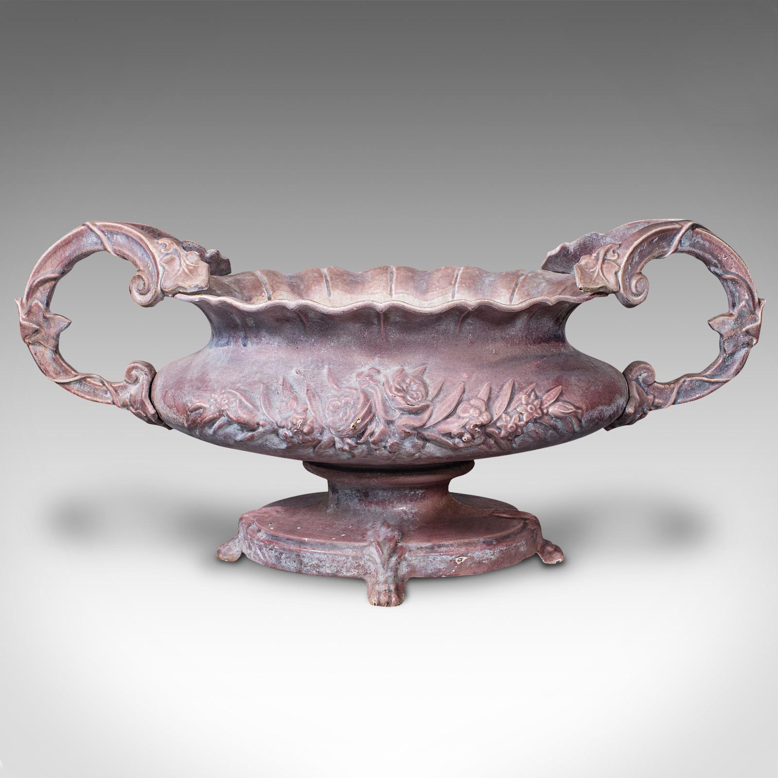 This is a large antique ornamental planter. An English, heavy enamelled cast iron jardiniere, dating to the early Victorian period, circa 1850.

Graced with bold form and of generous size, influenced by the exuberance of the Great