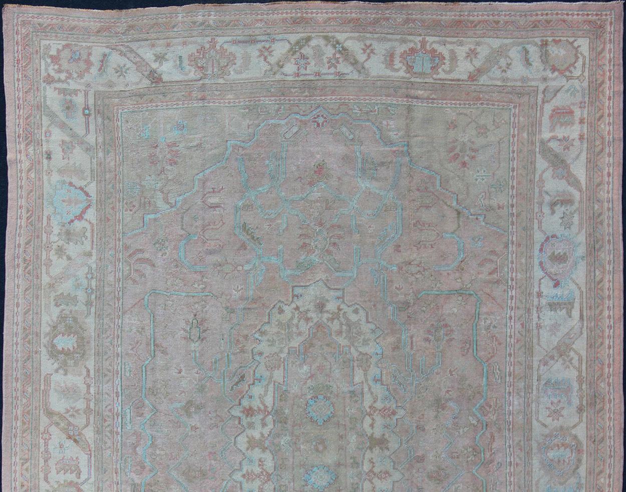 Turkish Large Antique Oushak Carpet in Light Pink Background with Light Blue Highlights For Sale