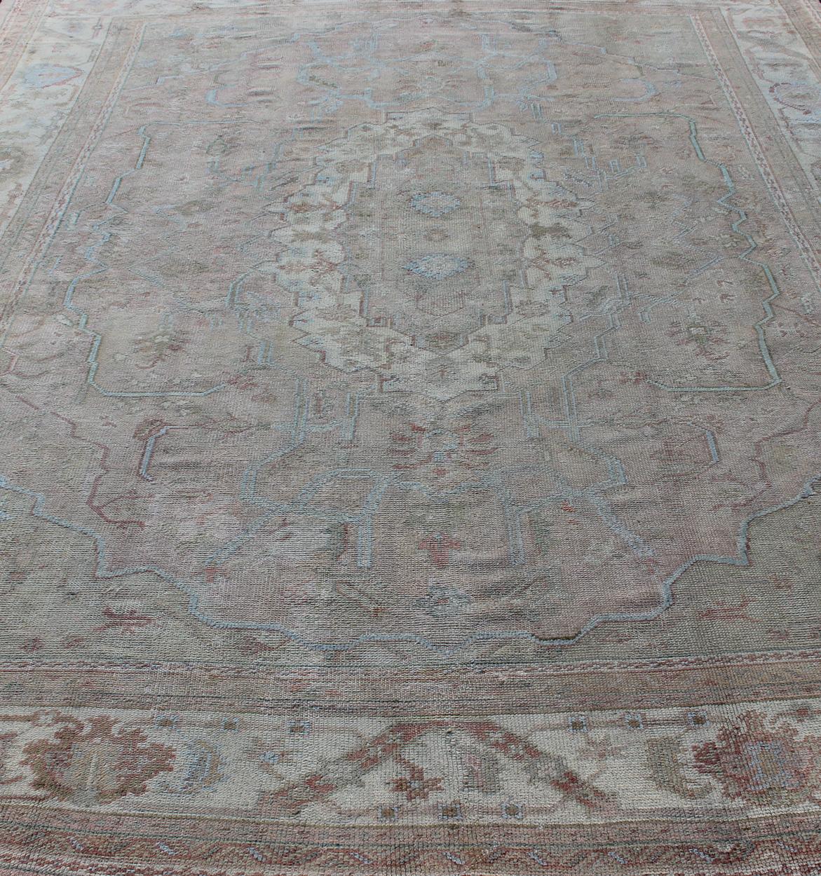 Wool Large Antique Oushak Carpet in Light Pink Background with Light Blue Highlights For Sale