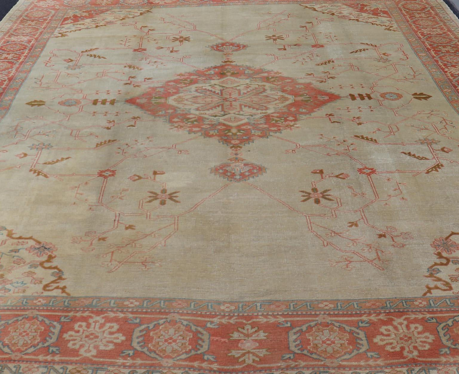20th Century Large Antique Oushak Rug in Taupe / Light Green Background and Coral Border For Sale