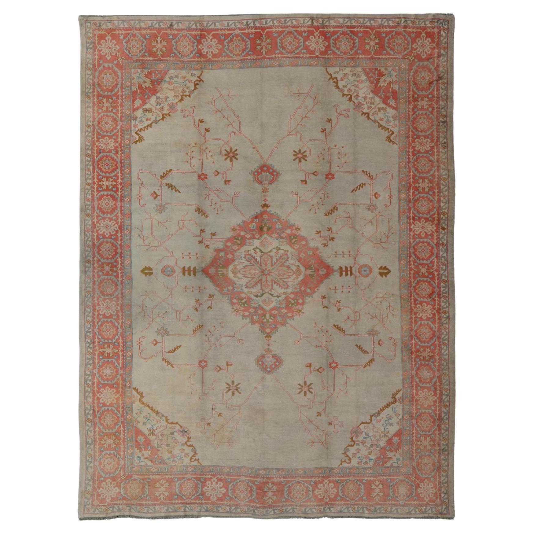 Large Antique Oushak Rug in Taupe / Light Green Background and Coral Border For Sale