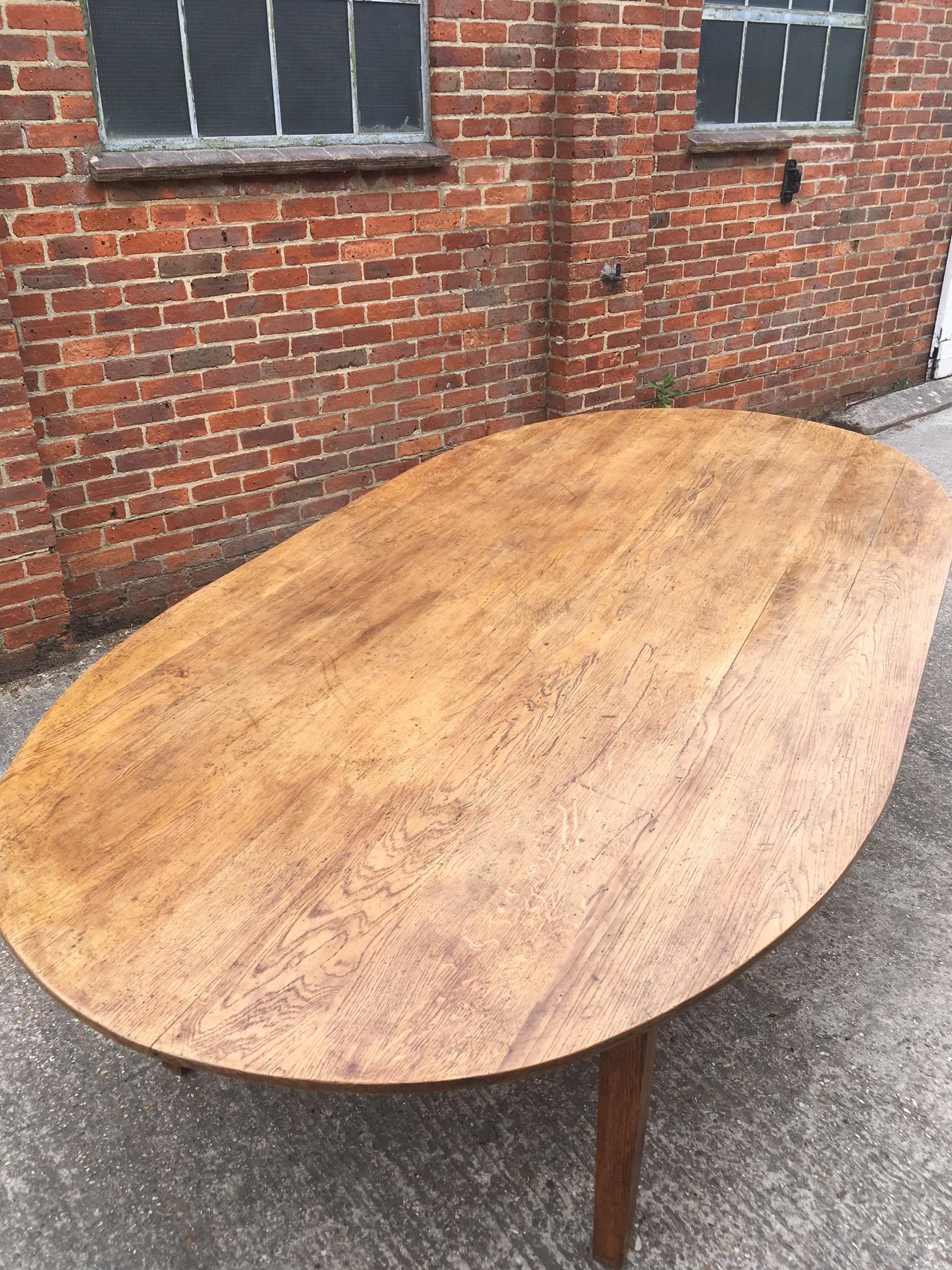 Large antique oval oak table with gorgeous grain and color, sits on four tapered sturdy legs, with very sturdy apron. Great size table would seat 14 people comfortably and with plenty of space for servicing dishes.


 