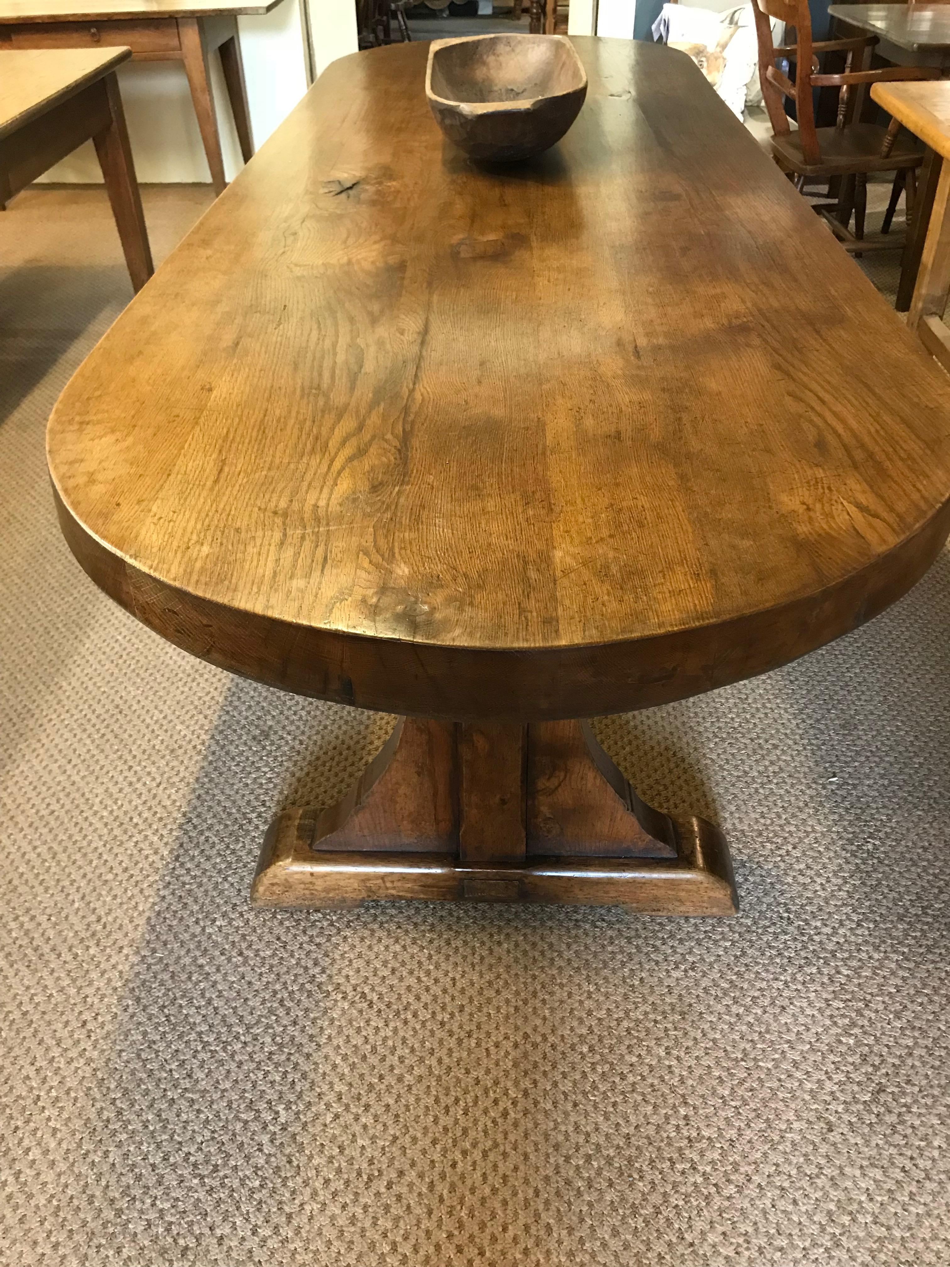 Large antique oval oak 19th century table with wonderful thick top, the table stands on two like trestle legs supported by a centre stretcher. The table is absolutely stunning with color and proportions to make it stand out from any crowd.

Oval