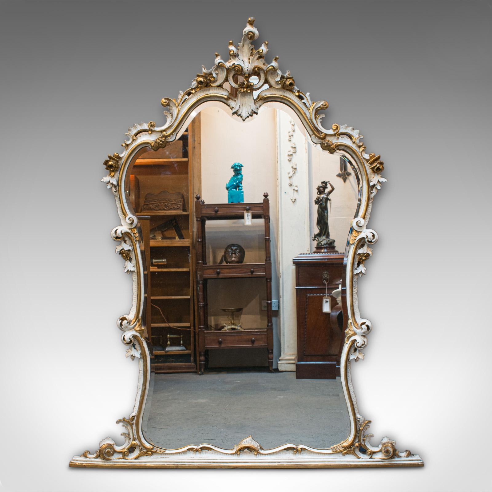 This is a large antique overmantel mirror. A French, gilt gesso and glass mirror with classical Italianate taste, dating to the late 19th century, circa 1900.

Impressive proportions to this grand mirror
Displays a desirable aged patina
Gilt