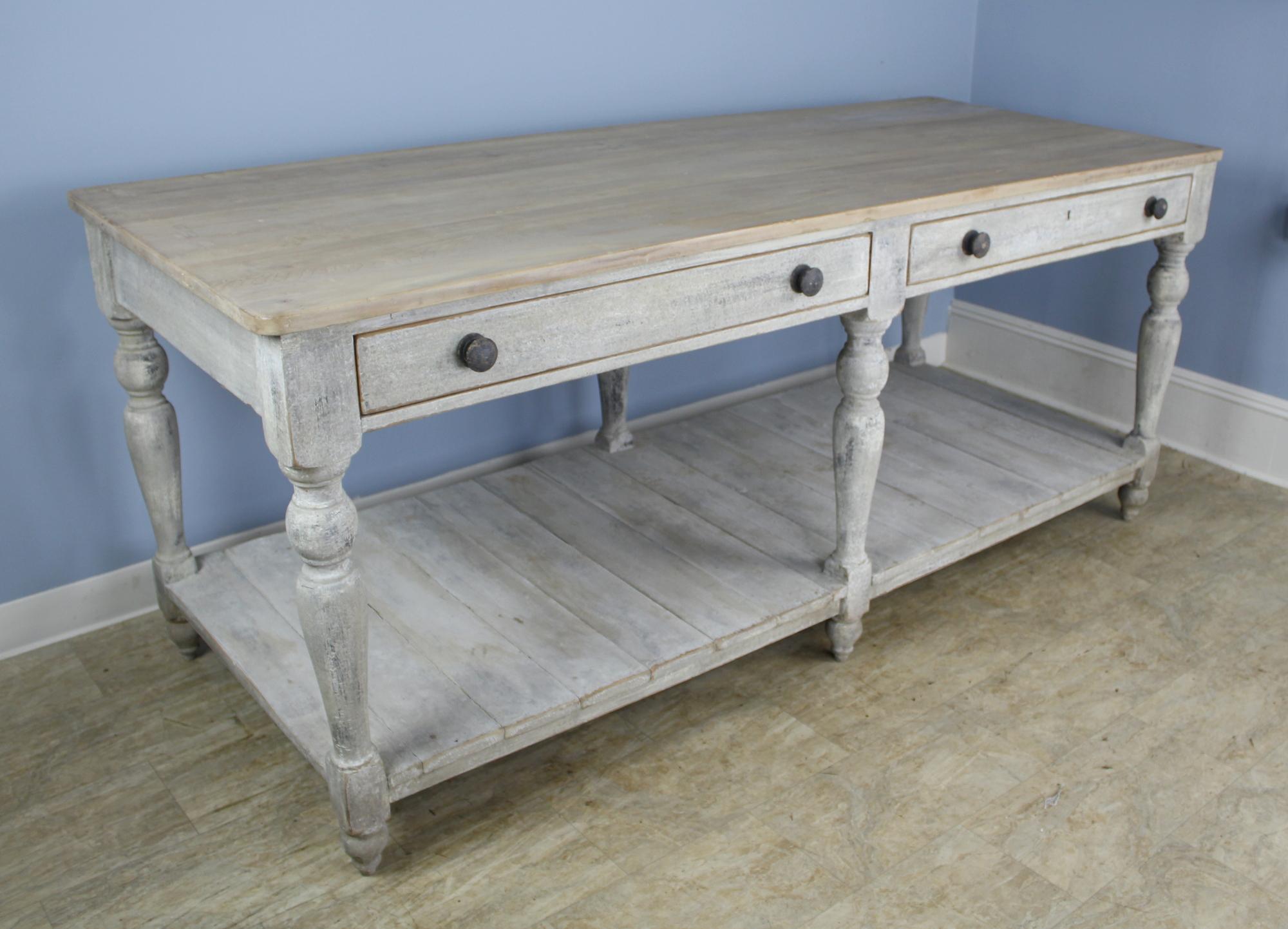 A fabulous prep or draper's table, newly painted for a distressed look. The top has been bleached for a clean appearance. The two wide drawers open and close easily and snugly. This can stand on it's own as a room divider or work table, or would be