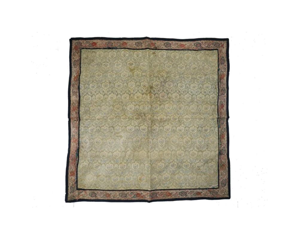 A large antique Persian Iranian Safavid dynasty hand woven textile blanket. The textile decorated with floral ornaments in warm tones. Circa 17th century. The Safavid dynasty, which ruled Persia from the early 16th to the early 18th century, is