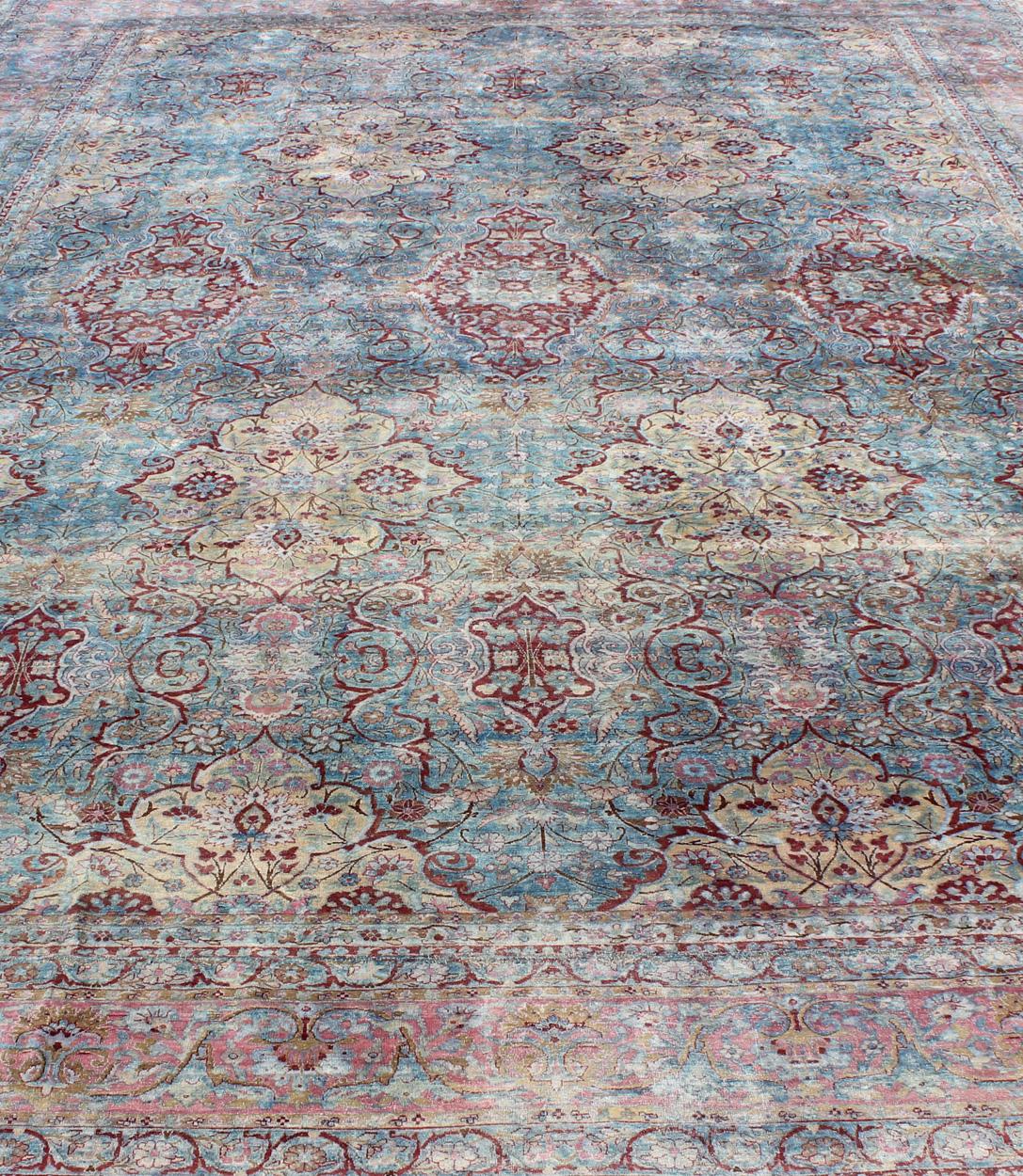 Wool Large Antique Persian Kerman Rug with Medallions in Light Blue, Red and Pink For Sale