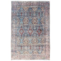 Grande tappeto antico persiano Kerman con medaglioni in azzurro, rosso e rosa