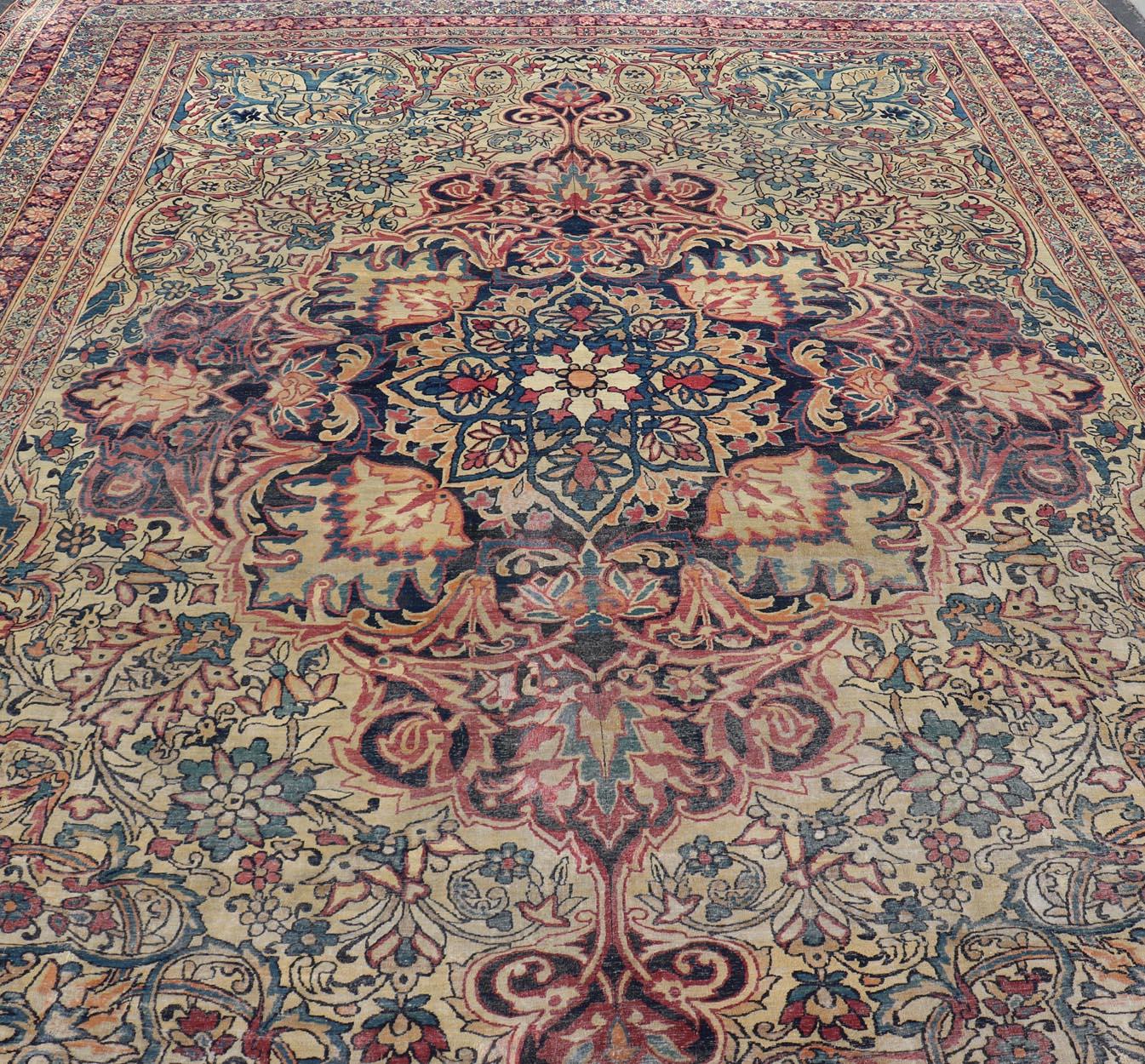 Kirman Large Antique Persian Lavar Kerman Rug with Blooming Central Medallion For Sale