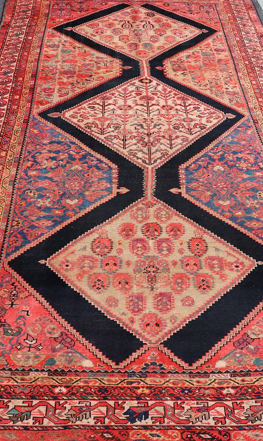 This Multicolored Antique Persian Malayer wide gallery runner features a geometric medallion design replete with Sub-geometric motifs. The entirety of the piece is enclosed within a complementary multi-tiered border. 

Antique Persian Malayer