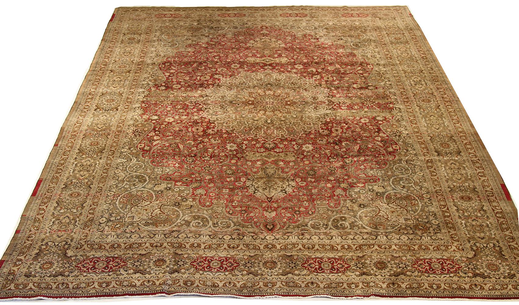 Antique Persian rug handwoven from the finest sheep’s wool and colored with all-natural vegetable dyes that are safe for humans and pets. It’s a special contemporary Mashad design featuring beige and brown floral details over a deep red field. It’s