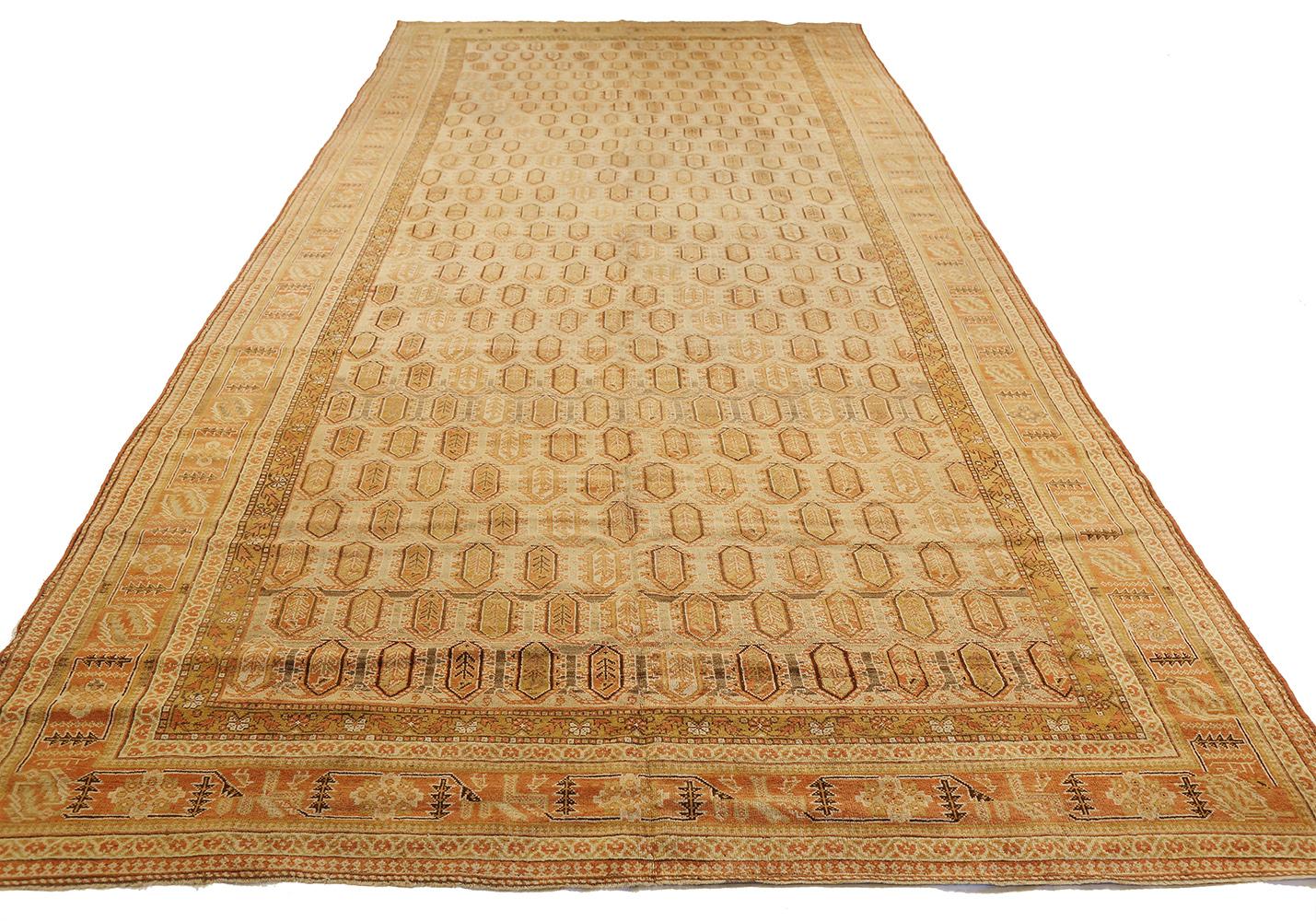 Antique Persian rug handwoven from the finest sheep’s wool and colored with all-natural vegetable dyes that are safe for humans and pets. It’s a traditional Shiraz design featuring orange and brown geometric details over an ivory field. It’s a
