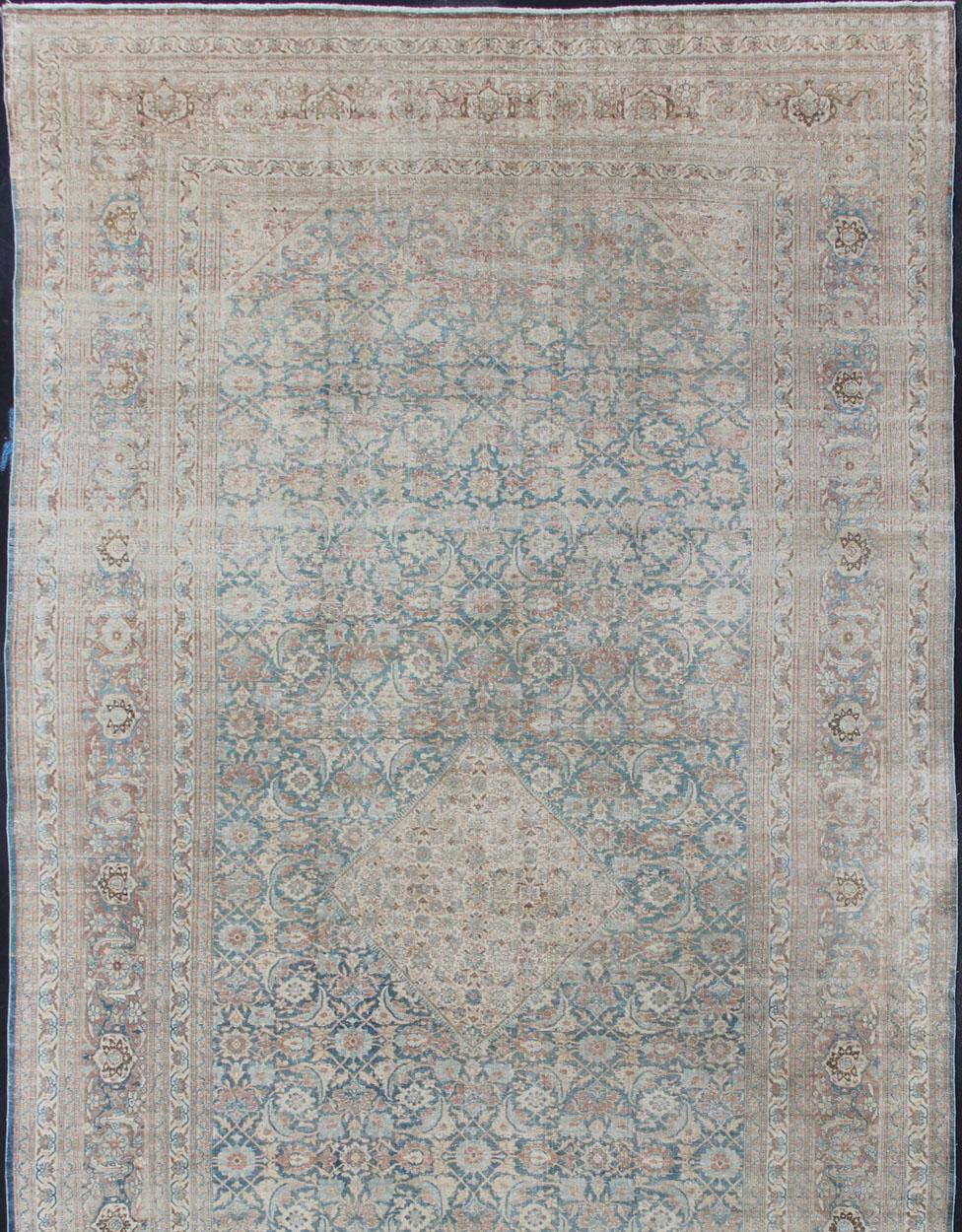 Cream, blue, charcoal and light brown and blue antique Persian Tabriz rug with Sub-Geometric all over Herati design, rug / KB-NA-180425, country of origin / type: Iran / Mahal, circa 1920

Measures: 12' x 23'2 

This antique Persian medallion