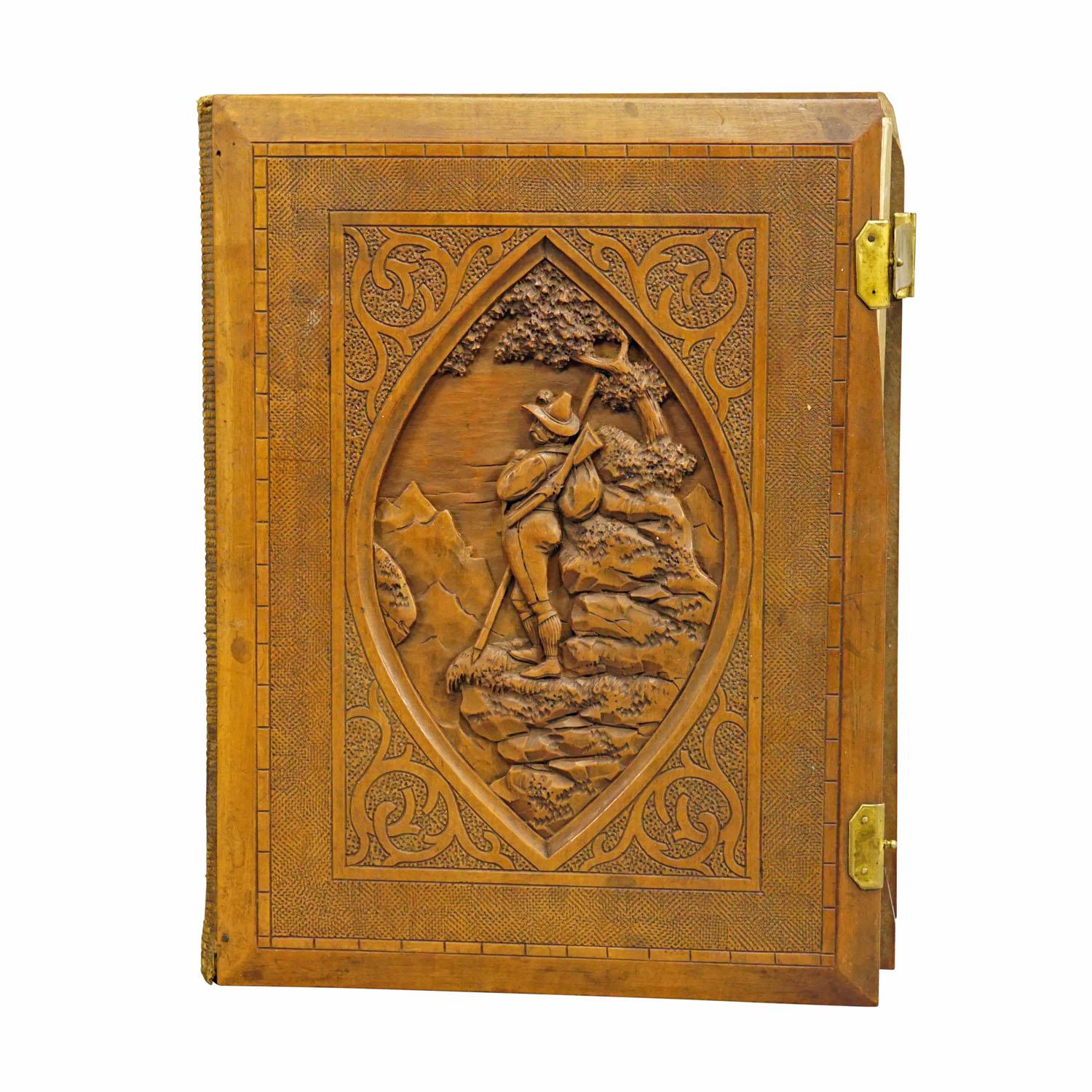Large Antique Photo Album with Wooden Carved Cover, Brienz ca. 1900

A lovely antique photo album featuring a lindenwood carved cover depicting a hunter in alpine enviroment. Handcarved in Brienz, Switzerland around 1900. Inside with several antique