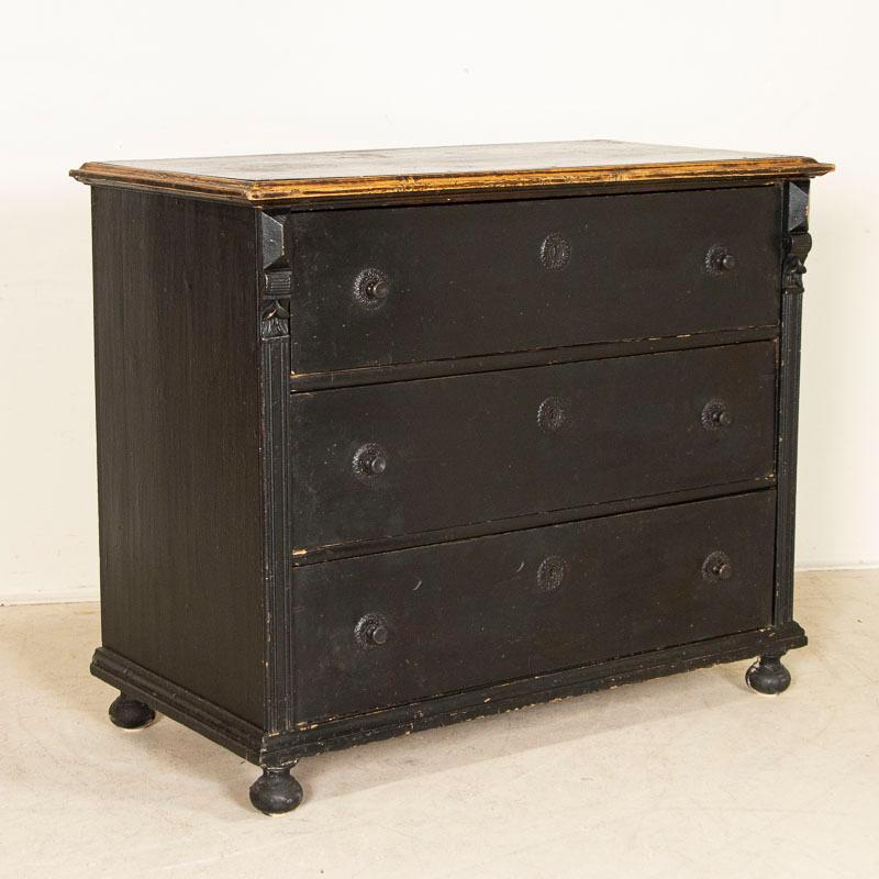 The beauty of this large chest of drawers or blanket chest is the simplicity of the lines and the 3 large, spacious drawers. The simple carved detail along the sides and bun feet were a traditional style element of the period while the pressed tin