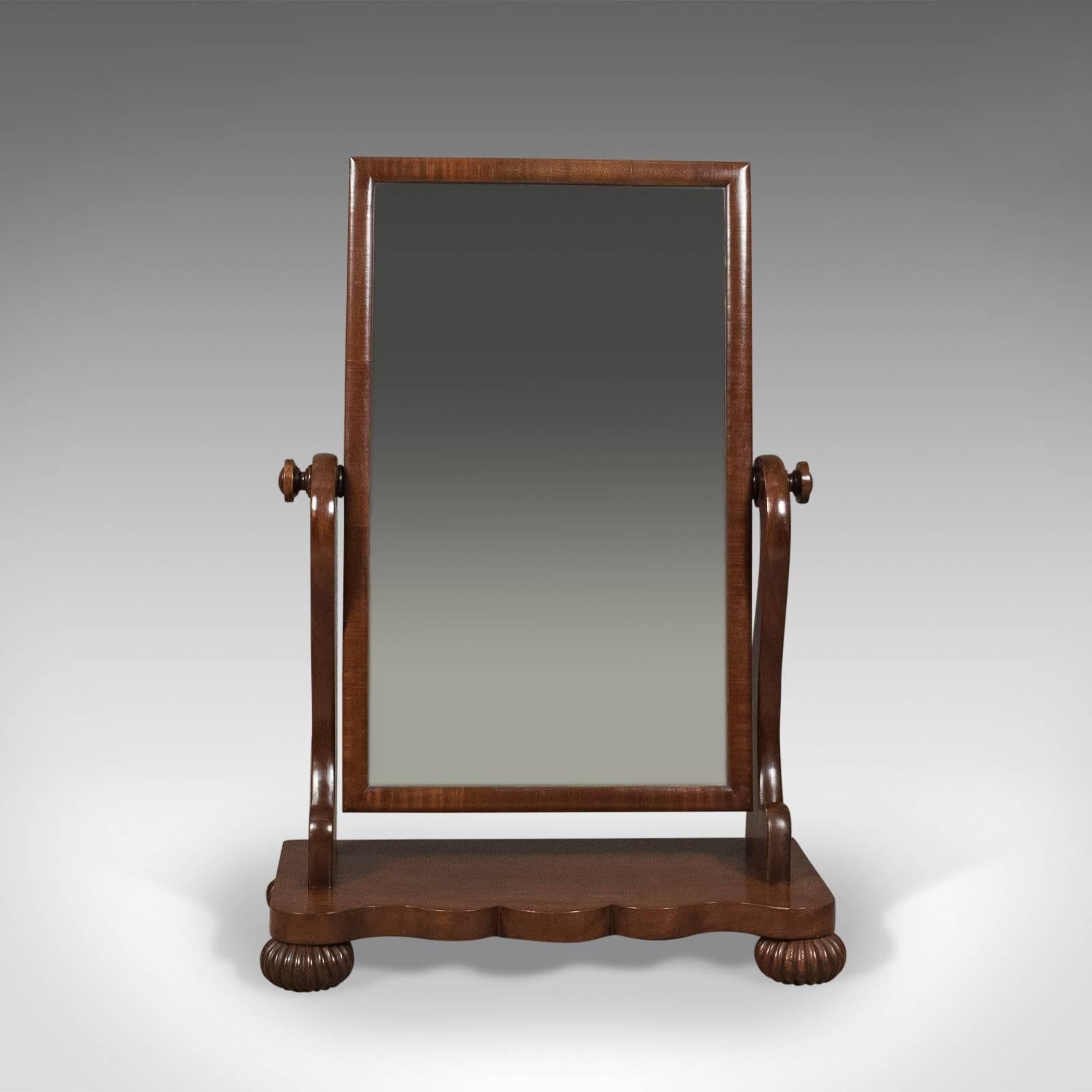 This is a large (over 3 feet tall) antique platform mirror in mahogany. English Victorian vanity, circa 1860.

A large adjustable mirror of country house proportions
Fine mahogany displaying grain interest and a desirable aged patina
Good