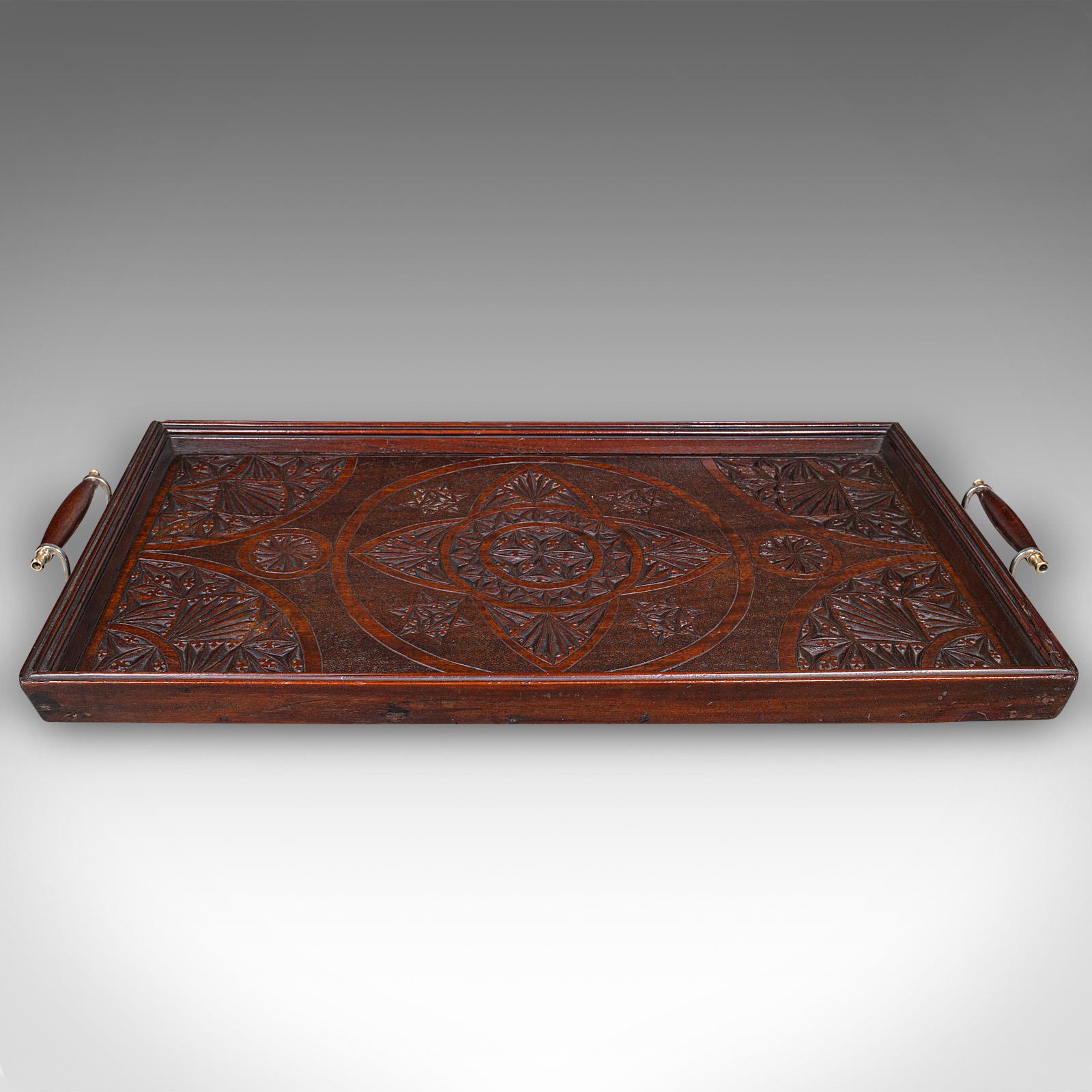 This is a large antique presentation tray. An English, mahogany afternoon tea serving platter, dating to the Edwardian period, circa 1910. Of fine proportion and quality craftsmanship, this piece combines practical function with elegant decorative