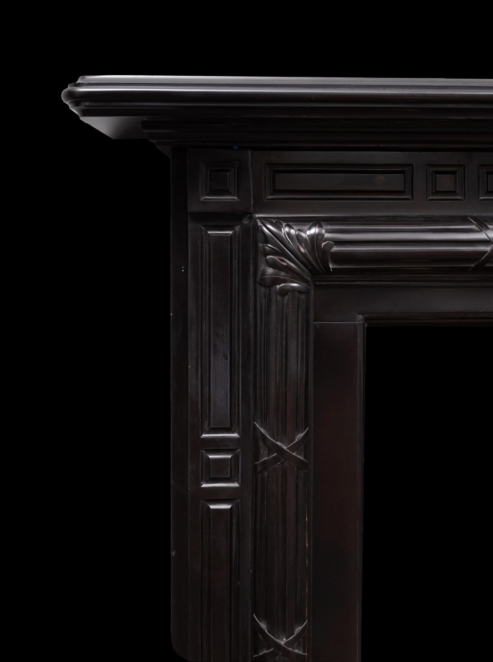 A large and stylish antique black marble fireplace surround
This unusual but well-proportioned, drawn and stylish black marble fireplace was made during the 1860’s in Belgian black marble.

It has a deep moulded shelf, fluted panelled pilasters