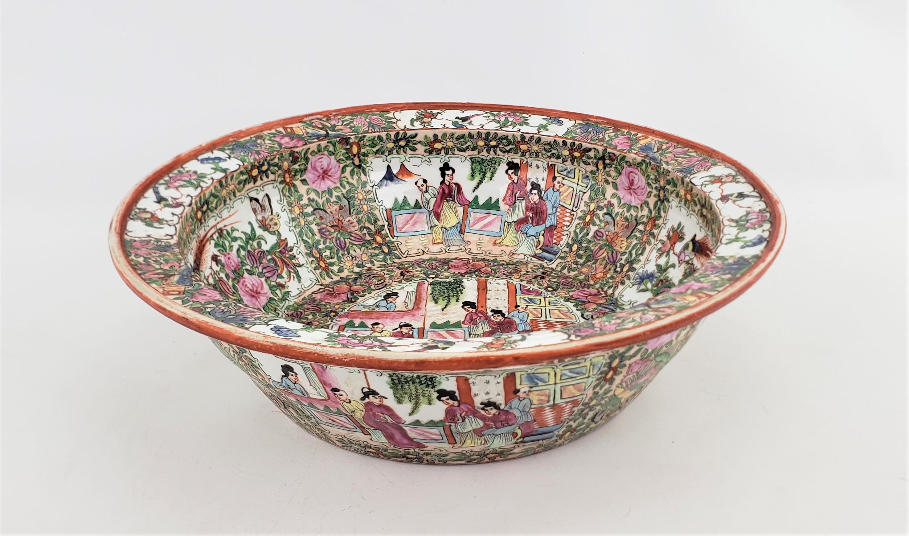 This very large and substantial bowl or basin is signed by and unknown artist and originates from China, dating to approximately 1920 and done in the period Chinese Export style. The entire bowl is very ornately hand-painted in vibrant colors in the