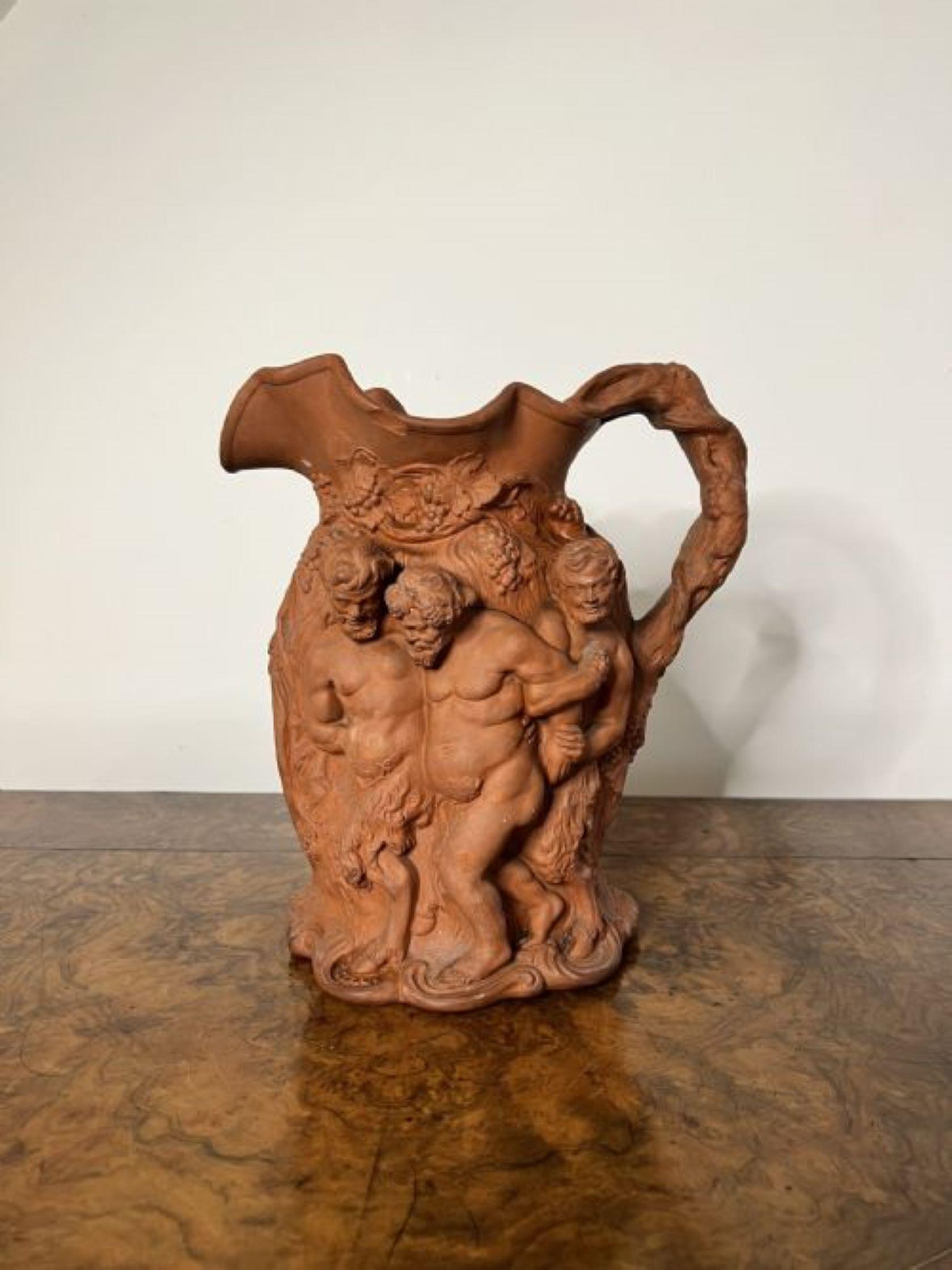 Large antique quality relief moulded terracotta jug modelled in relief images of Bacchus with a shaped handle to the back. 
Unfortunately one of the legs is broken on one of the figures.
