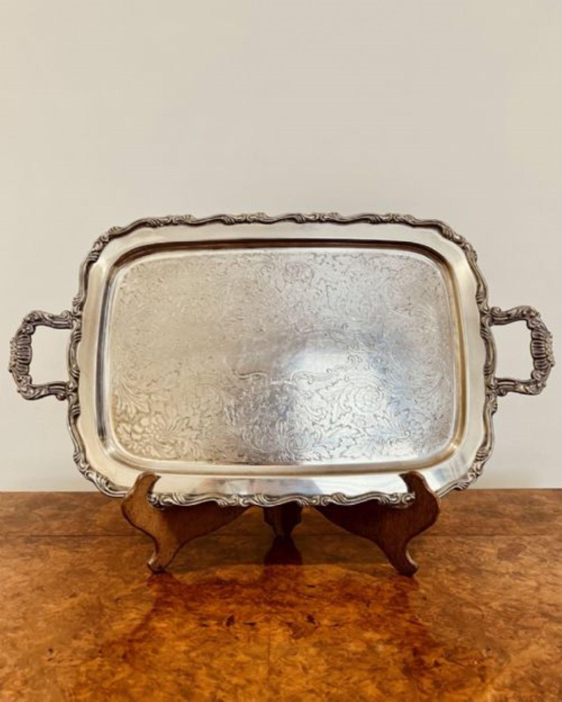Large antique quality silver plated engraved tea tray having a quality silver plated engraved tea tray with a ornate edge and two ornate carrying handles 