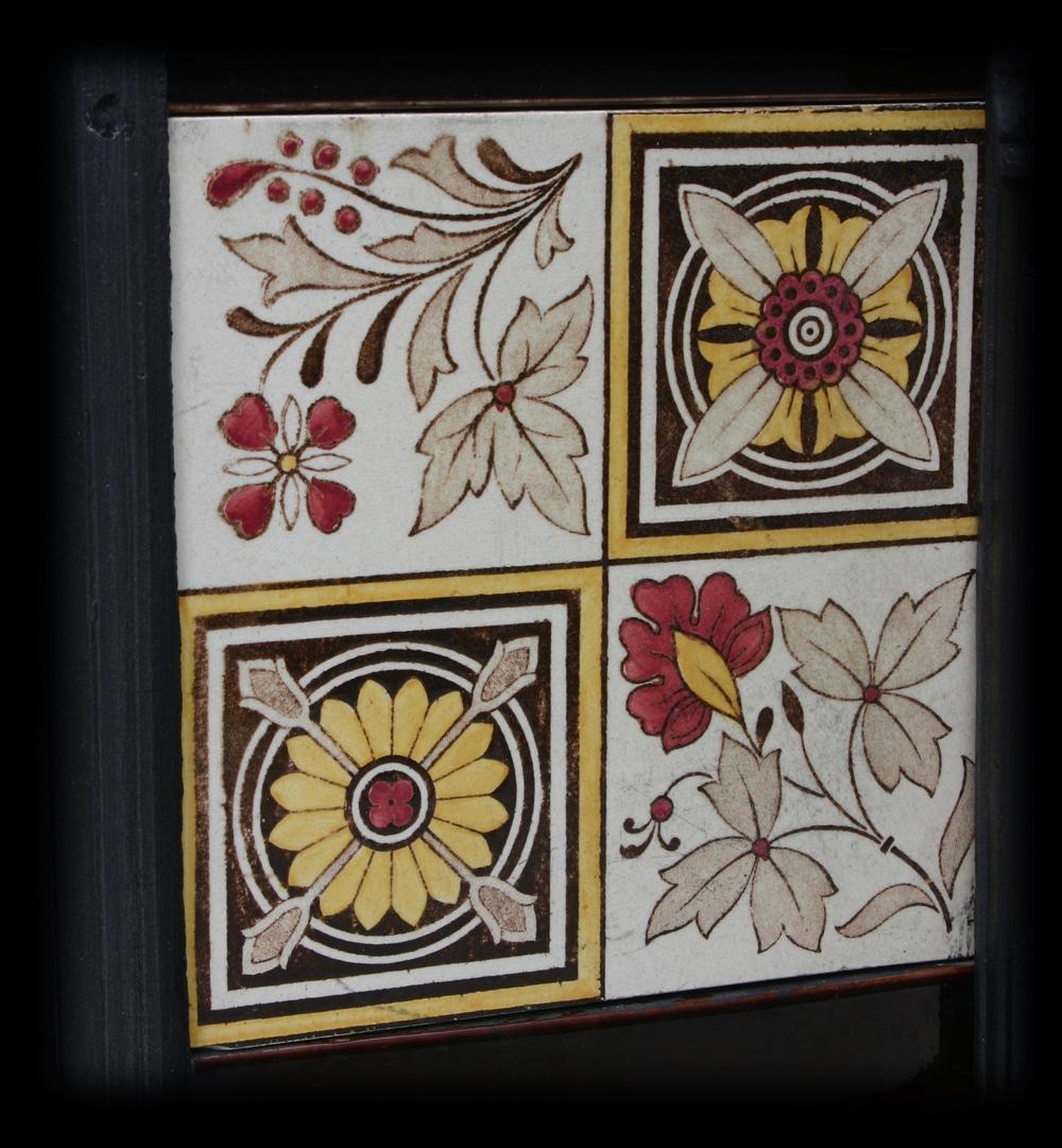 Large reclaimed Victorian cast iron insert in the Arts & Crafts manner, with simple reeded frame, also reflected in the canopy which has a rose to the center, circa 1880. Complete with a set of original antique fireplace tiles also in the Arts &