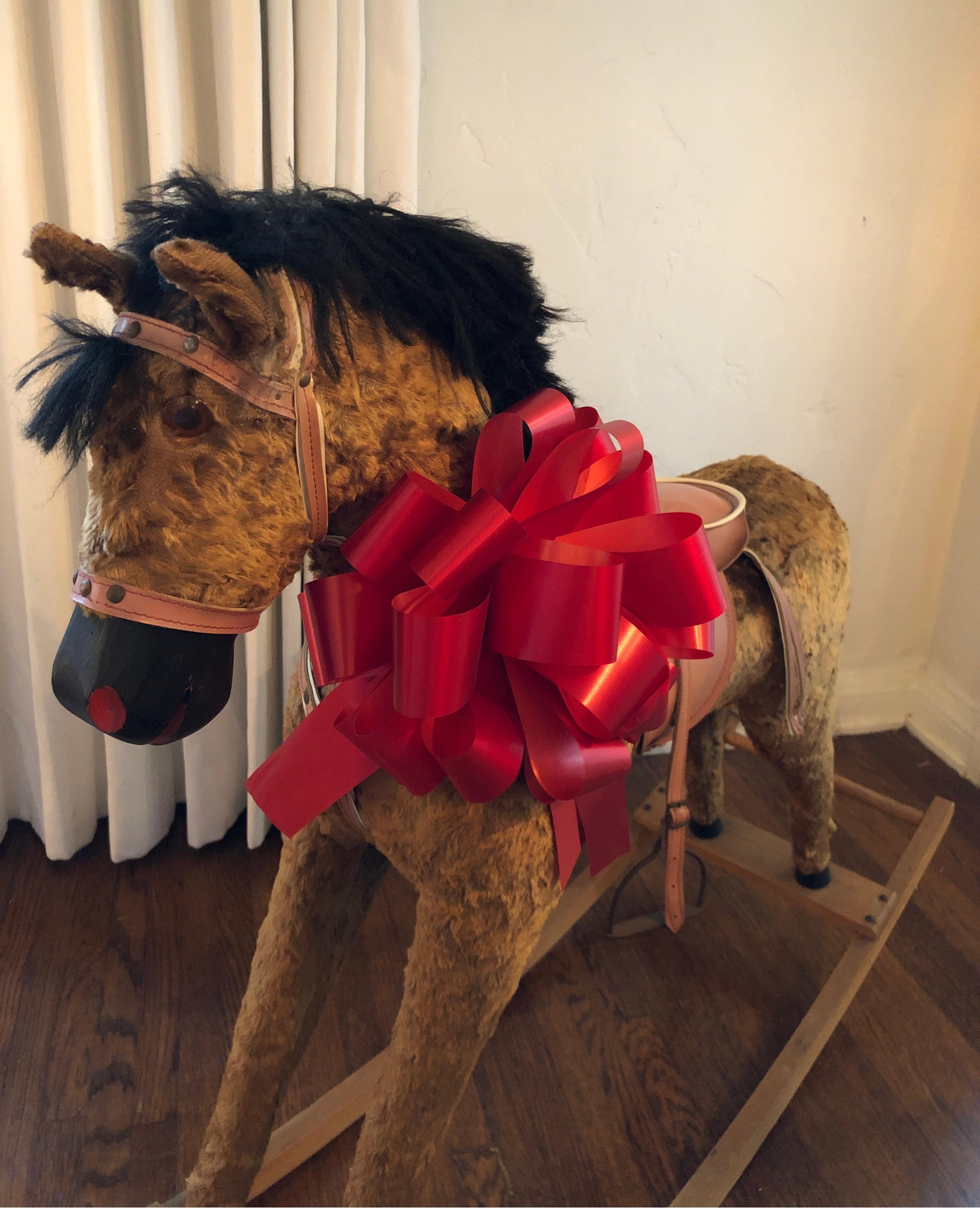Carved wood rocking horse with velvet type fur.
Complete with saddle and one iron stirrup.
Overall solid condition with signs of use consistent with age.
Ready for a child's bedroom.
Measures: 31” H 42” L x 12” W.