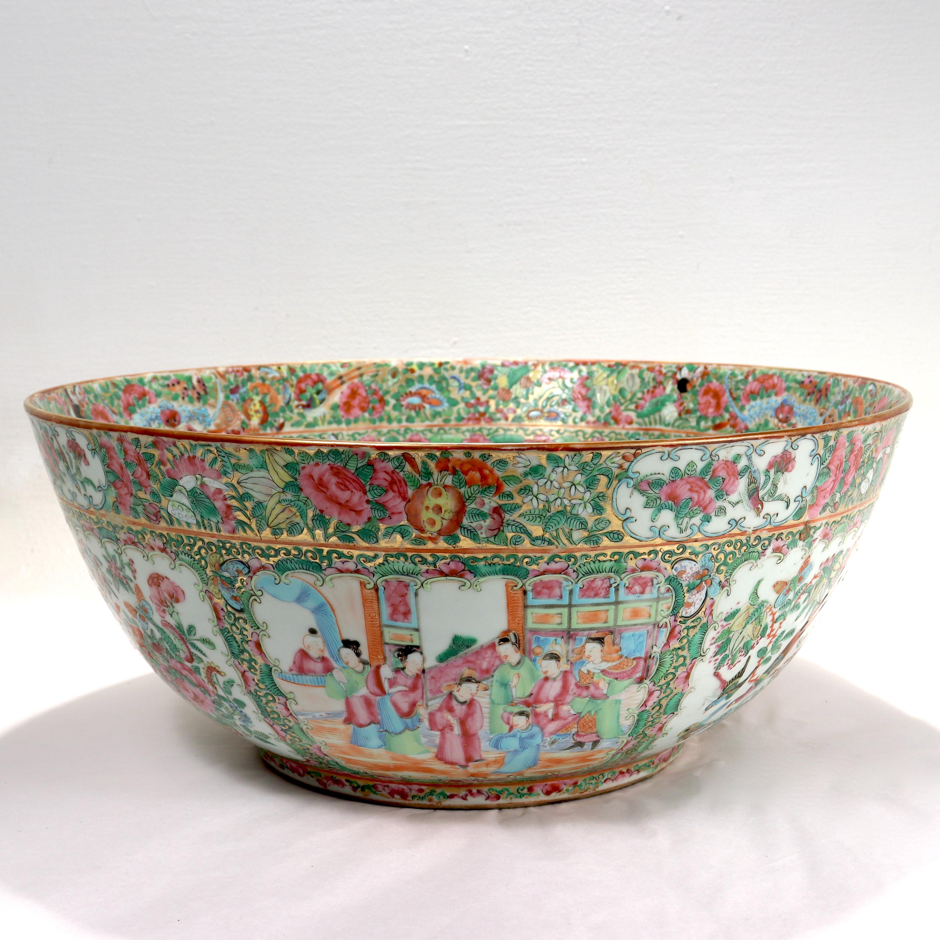 A large antique Chinese porcelain punch bowl.

With Rose Medallion (Famille Rose) decoration.

The central cartouche of the bowl depicts a court scene. Both the interior and exterior walls of the bowl have 6 cartouches which each alternate between