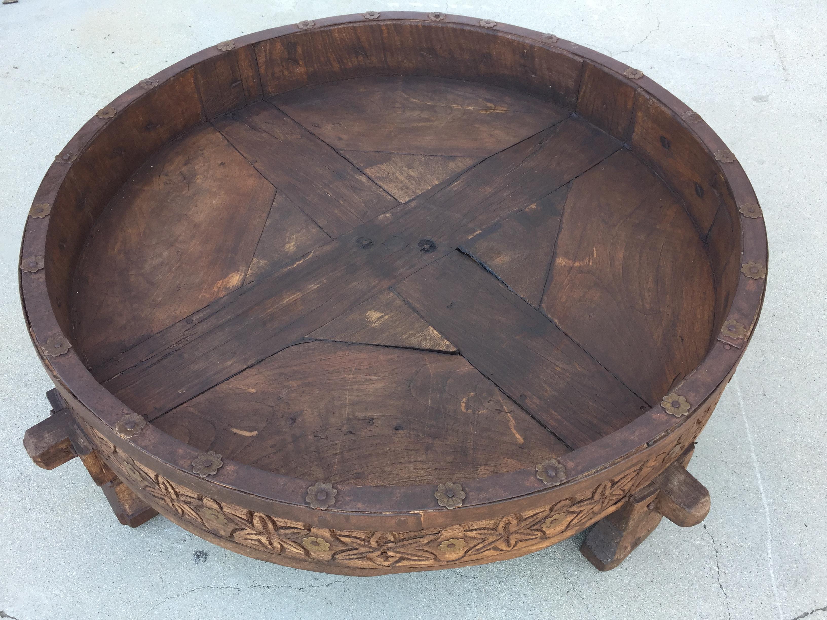 Large antique hand carved wood Indian grinder tribal teak table.
Dark walnut color hand carved with geometric African design.
Handcrafted of wood and iron, hand carved with geometric Ethnic tribal design.
Very sturdy rustic wood table with nice