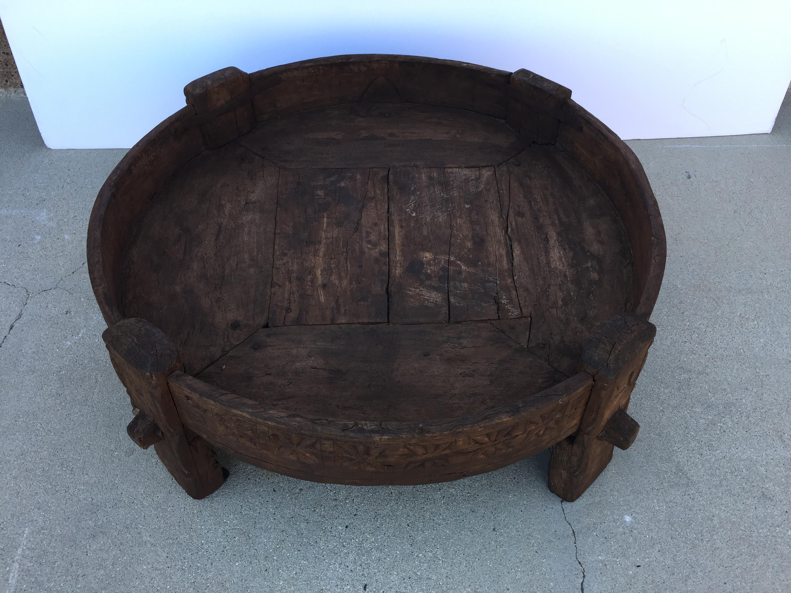 Large hand carved wood Indian grinder tribal table.
Dark walnut color hand carved with geometric African design.
Handcrafted of wood and iron, hand carved with geometric Ethnic tribal design.
Very sturdy rustic wood table with nice patina,